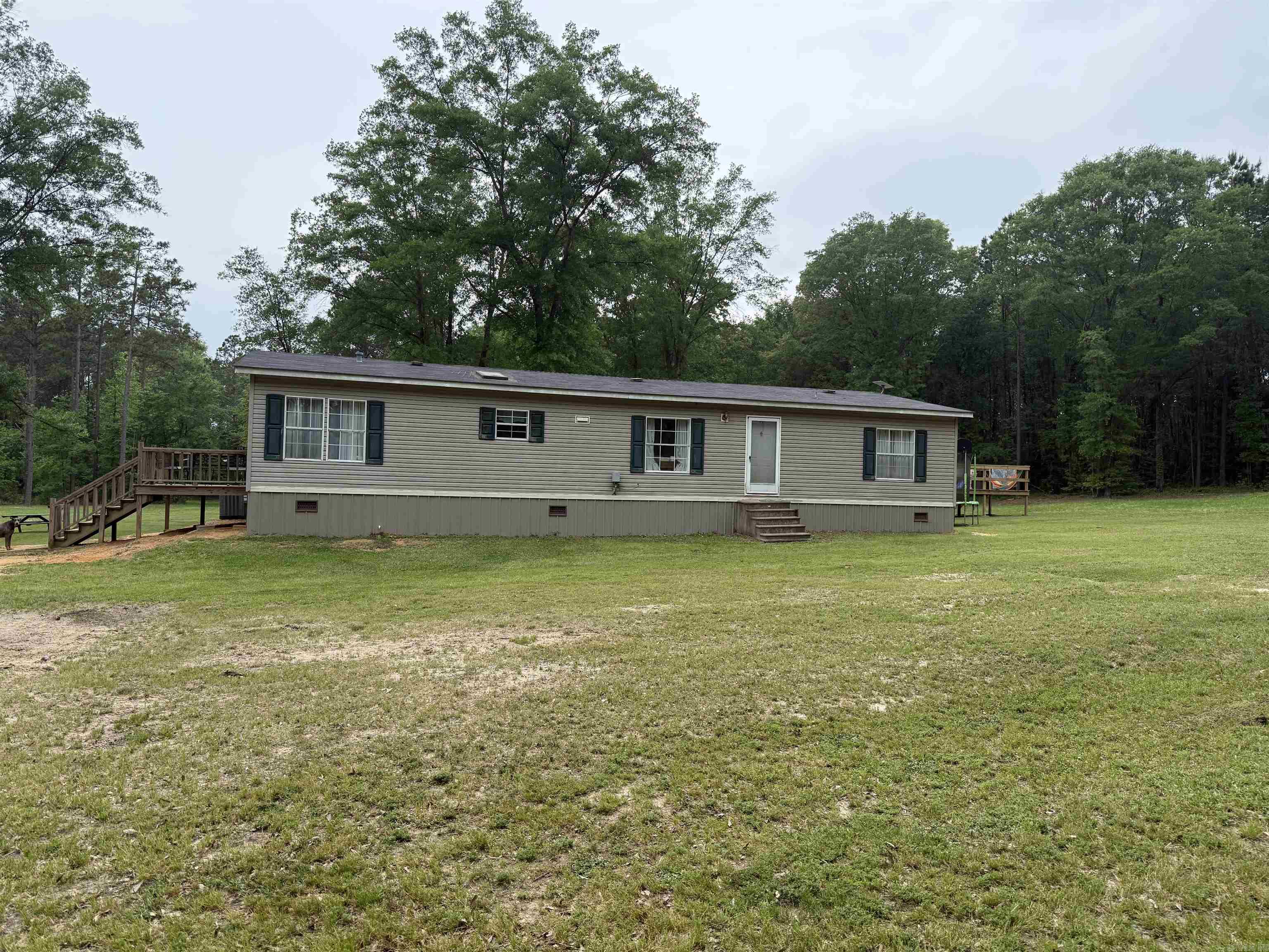 Looking for the perfect spot, country living, close to town with lots of privacy, this property offers approx 37 acres minutes from downtown Nashville, home offers approx 1,624 sq ft of living space with 3 bedrooms and 2 full baths. This mobile home has been well maintained and is move in ready. Large living room, spacious kitchen w/lots of cabinet space, pantry, dining area and laundry nook. All appliances to convey, including refrigerator, dishwasher and electric range. Split floor plan with large master, walk in closet, master bath with jacuzzi tub and separate shower. Home is all electric, newer hot water heater and CH/CA unit replaced in 2023. Covered deck and additional detached large entertaining deck, storage building and shop building. For more details or to schedule a private showing, contact our office.