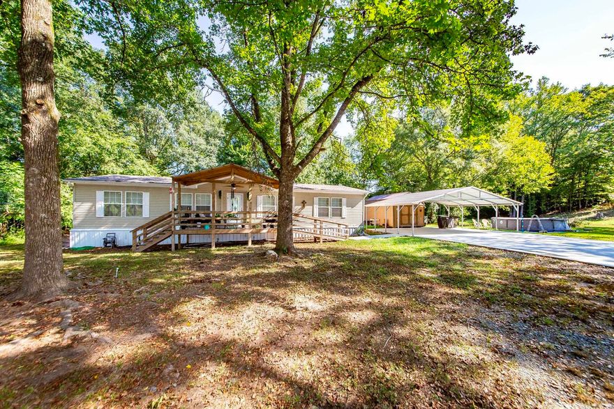 There's nothing "mobile" about this home! Located on the outskirts of Hot Springs in Mountain Pine School District-luxury meets affordability. Just 5 minutes from Lake Ouachita, this property sits on 3 beautiful acres with a creek and includes; a permanent foundation, master suite with built in vanity and soaker tub, walk in closets in each room, hardwood floors throughout, a freshly poured concrete driveway, a brand new backyard fence, a 3 year old front deck with ramp, a large 3 car carport, a storage shed, and an outbuilding with brand new wiring, insulation, and sheet rock installed. HVAC is just 1 year old and the roof is just 2! A comprehensive list of other upgrades will also be provided. This is a must see! AGENTS SEE REMARKS FOR SHOWING INSTRUCTIONS