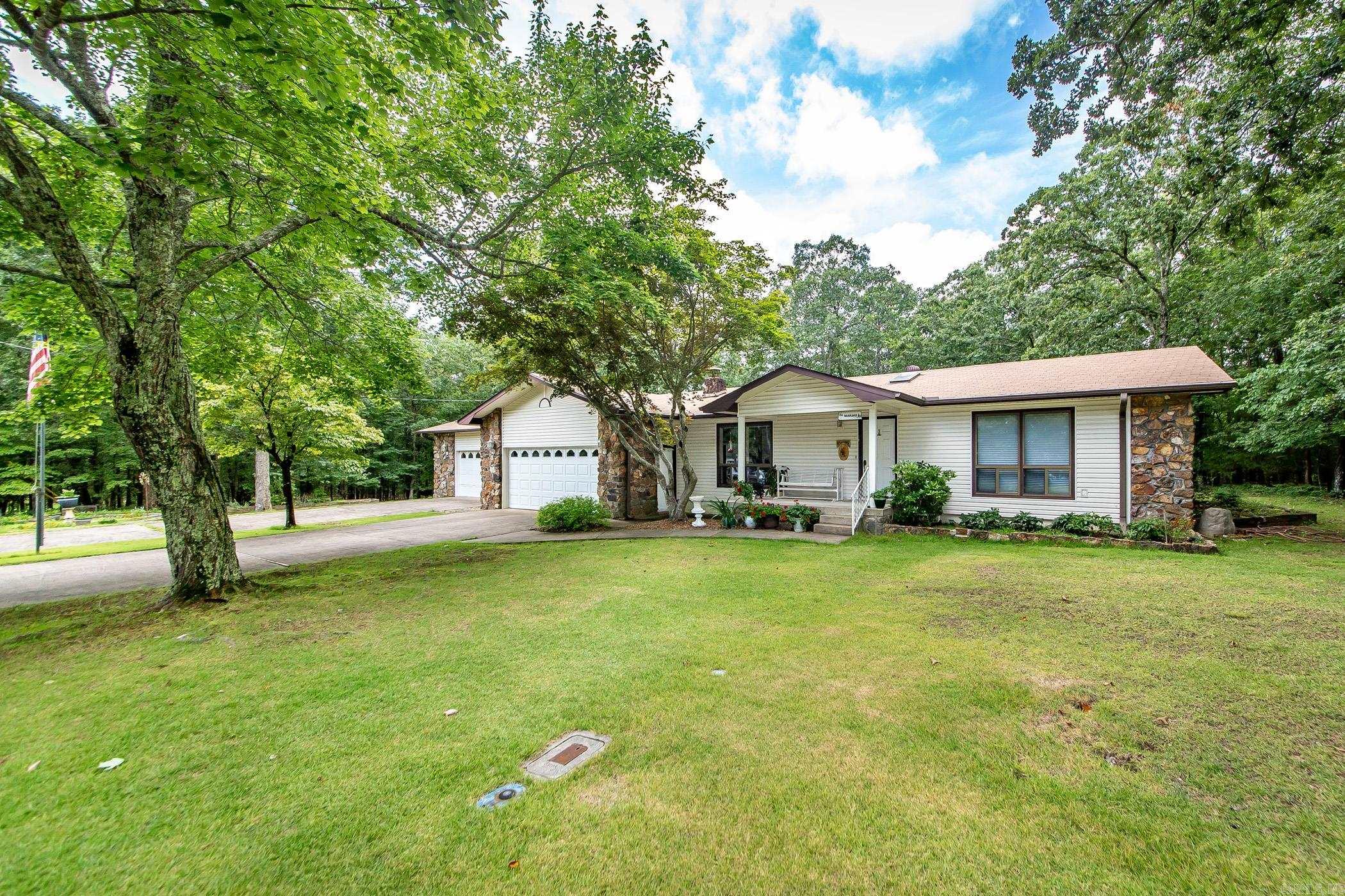 Welcome to your dream home nestled on a quiet, tree-lined street! This inviting property boasts a spacious three-car garage with a connected workshop areaāperfect for your hobbies or storage needs. The extra-large, level lot offers a secure, fenced gardening area ready for your green thumb and a detached workshop for all your creative or home business projects. Imagine relaxing or entertaining on the expansive deck, complete with a sparkling poolāideal for those warm summer days! Enjoy evenings on the classic front porch, where you can soak in partial views of the lake and peaceful surroundings. Step inside to find a generous master suite, offering ample space and privacy, ideal for your comfort and relaxation. The home is conveniently located near scenic trails and just minutes from the amenities of the bay. Plus, youāll be only a 10-minute drive from the fabulous Greers Ferry Lake, making weekend getaways and water adventures a breeze! Donāt miss this unique opportunity to own a well-maintained home with room to grow and play, close to natureās best offerings. Schedule your private tour today!