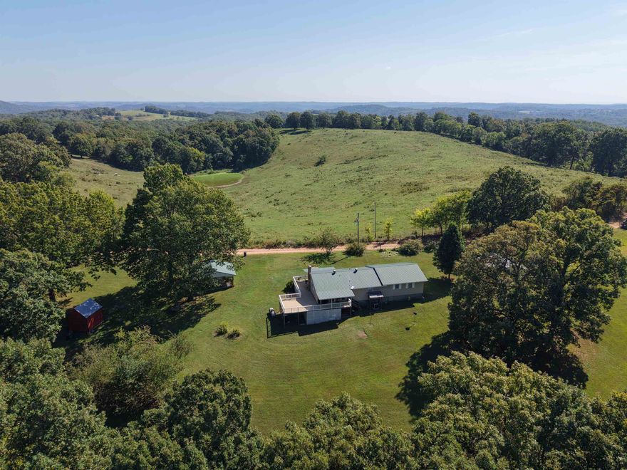 Residing on 2 acres in the heart of the Ozarks, this modern farmhouse-style home offers 3 bedrooms and 1 bathroom.  Updated throughout, this property is ready for its next owner—featuring a newer HVAC system, updated hot water heater, and fresh finishes inside and out. Additionally, the washer and dryer are inlcuded, making this home truly turnkey.  The property offers mature landscaping, a well-kept yard, and established fruit trees. Several outbuildings give you plenty of space for storage, projects, or outdoor equipment. Relax outdoors no matter the season with a spacious back deck and covered porches on both the front and back of the home—perfect for quiet mornings, evening gatherings, or simply enjoying the secluded mountain surroundings. With county road frontage, public water, and high-speed internet, this property blends modern convenience with true Ozark living. Priced at only $214,500.