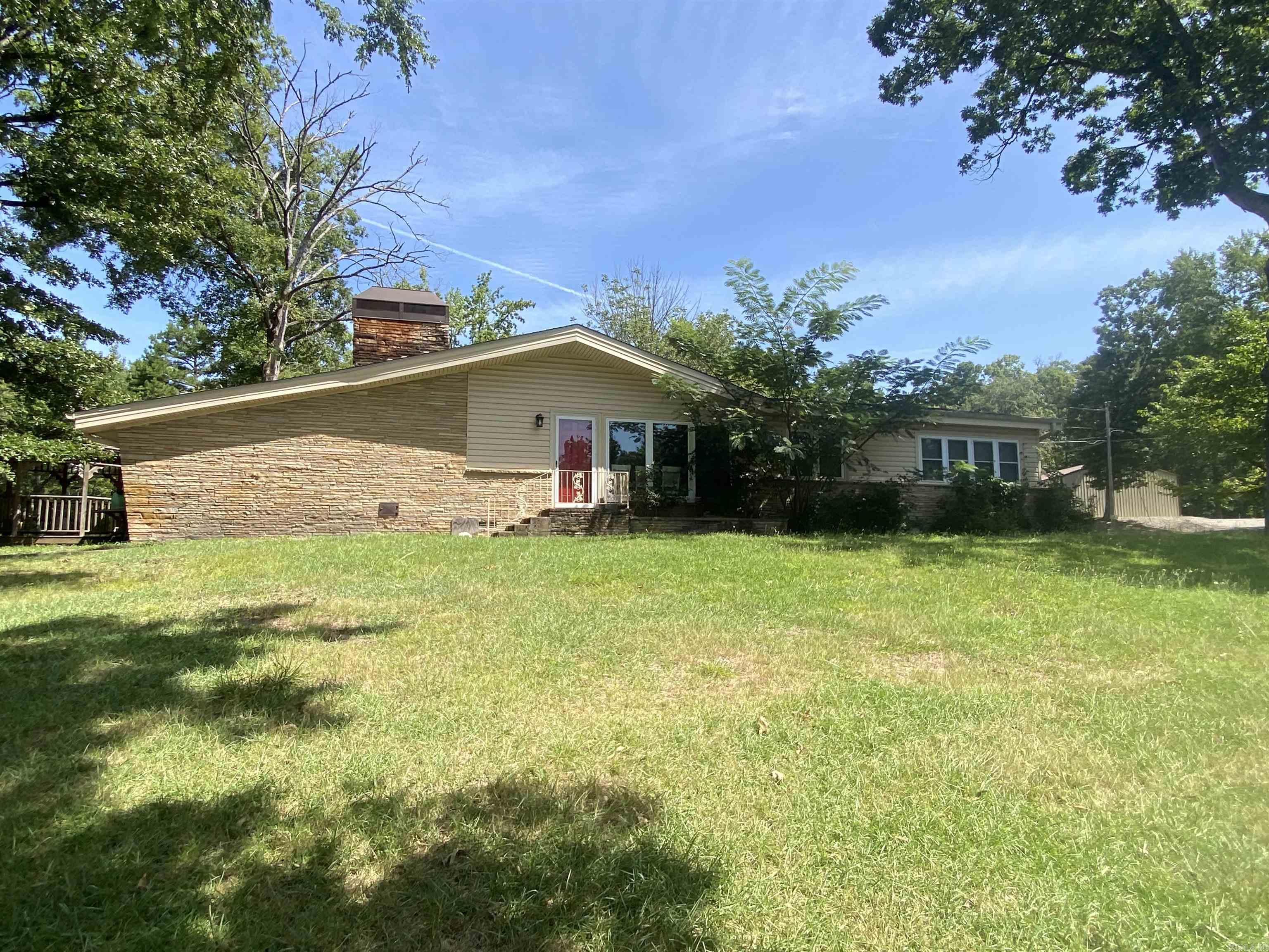 Here's a vacation home just for you and your family! This is property is in one of the most desired locations in Montgomery County. 9 White Oak is located between Shangri-La & Lake Ouachita Shores (Denby Point) and you know how hard it is to find a place there! With 3 bedrooms and 2 baths, this 1802 square foot home has plenty of room for all your family and friends to visit. Both the dining area and the great room feature the "exposed beam" feel on the ceilings. A lovely brick fireplace and an enclosed back porch, that is heated and cooled, are just a few of the extras you will love. The floors are tile and hardwood throughout for easy cleaning. Relax under the gazebo off the carport, which is a great place for grilling! This property includes 20'x30' shop & a 12'x25' boat awning, along with an outside storage area. Don't miss out on this one! $260,000.00
