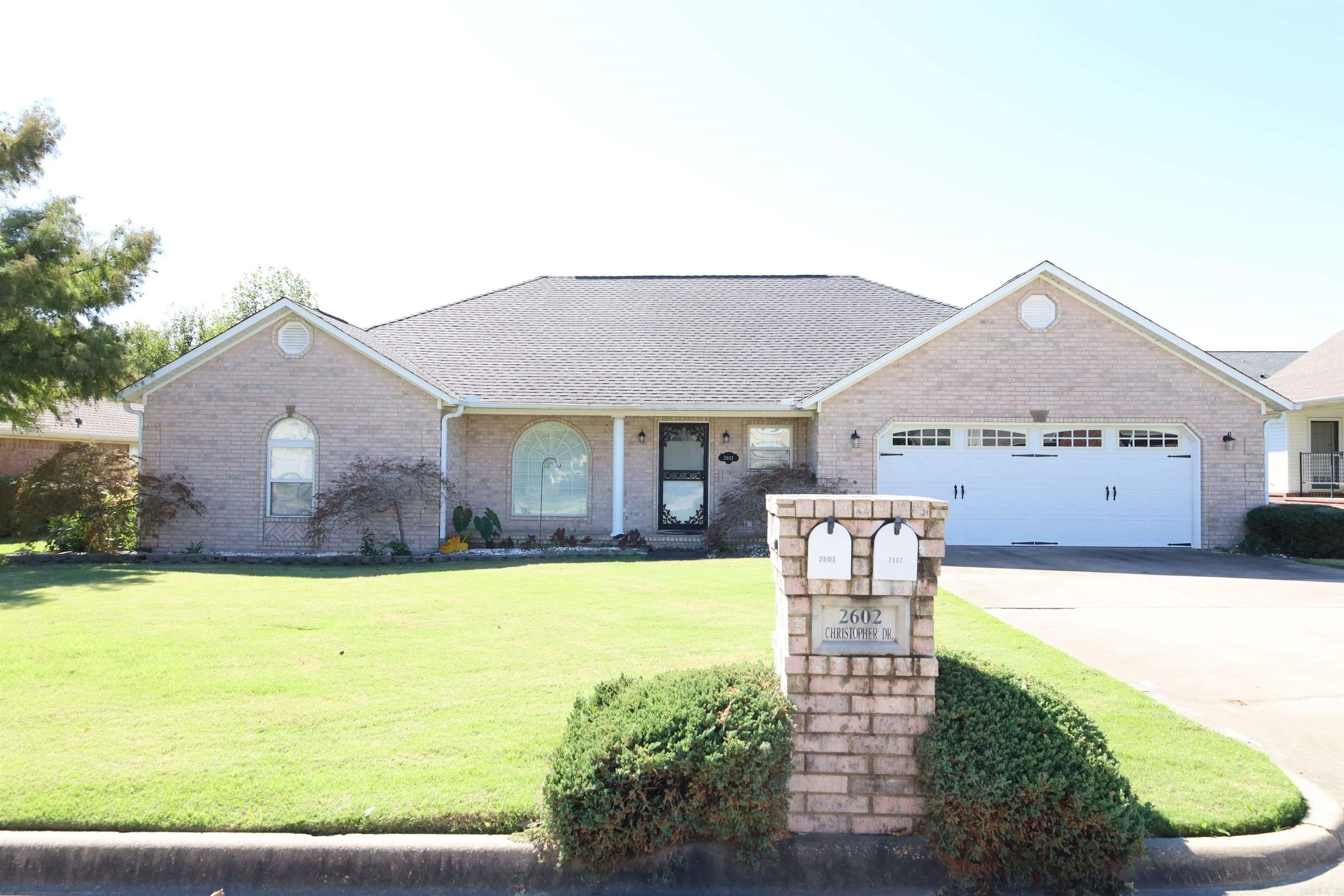 This lovely brick home features three bedrooms and two bathrooms, offering a spacious and inviting environment. The main living area boasts vaulted ceilings, creating an open and airy feel. The kitchen is well-equipped with stainless steel appliances and an abundance of cabinets, providing ample storage for all your culinary needs. Enjoy the sunshine in the sunroom or relax on the covered back porch, overlooking a privacy-fenced backyard that includes a convenient storage building. The large main suite is a true retreat, featuring coffered ceilings and a generous main suite bath, complete with double "his and hers" closets for plenty of storage. Additional highlights of this home include a newer roof and HVAC system, ensuring comfort and peace of mind. This property is a perfect blend of functionality and style, making it a wonderful place to call home!