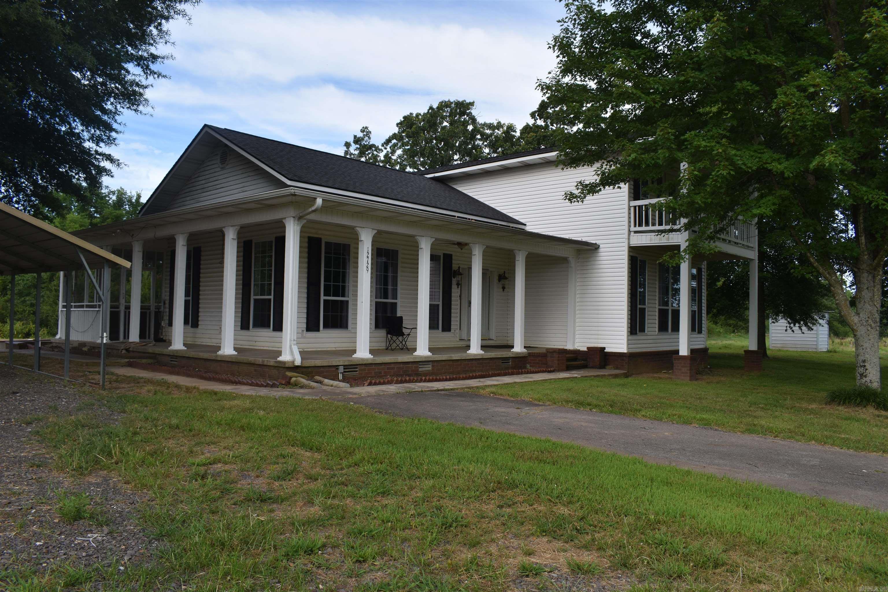 As you pull into the paved, tree lined driveway of this two-story custom home, youll immediately be able to see the country charm that surrounds this Scott County Estate. Sitting on 13 +/- Acres and totaling 2500 Square Feet heated and cooled, this property is spacious both inside and out. The custom-built home is full of features that separate it from your typical home. The high ceilings in the living area, along with the crown molding and loft overlook are just a few of these features. The home has a large master suite down stairs, along with a spacious kitchen, living area, and mud room. Upstairs, two bedrooms with a jack and jill style bathroom have beautiful views to both the north and south. A two-car carport, as well as an unfished detached two car garage giving plenty of space for all of your vehicles and outdoor equipment. On the west side of the yard, there are two camper hookups complete with power and water. The six-acre fenced pasture on the west side of the property is the perfect spot for cattle or horses, and has a stocked pond as well. This charming country home has a lot to offer, and is located in one of the most sought-after areas in the county.