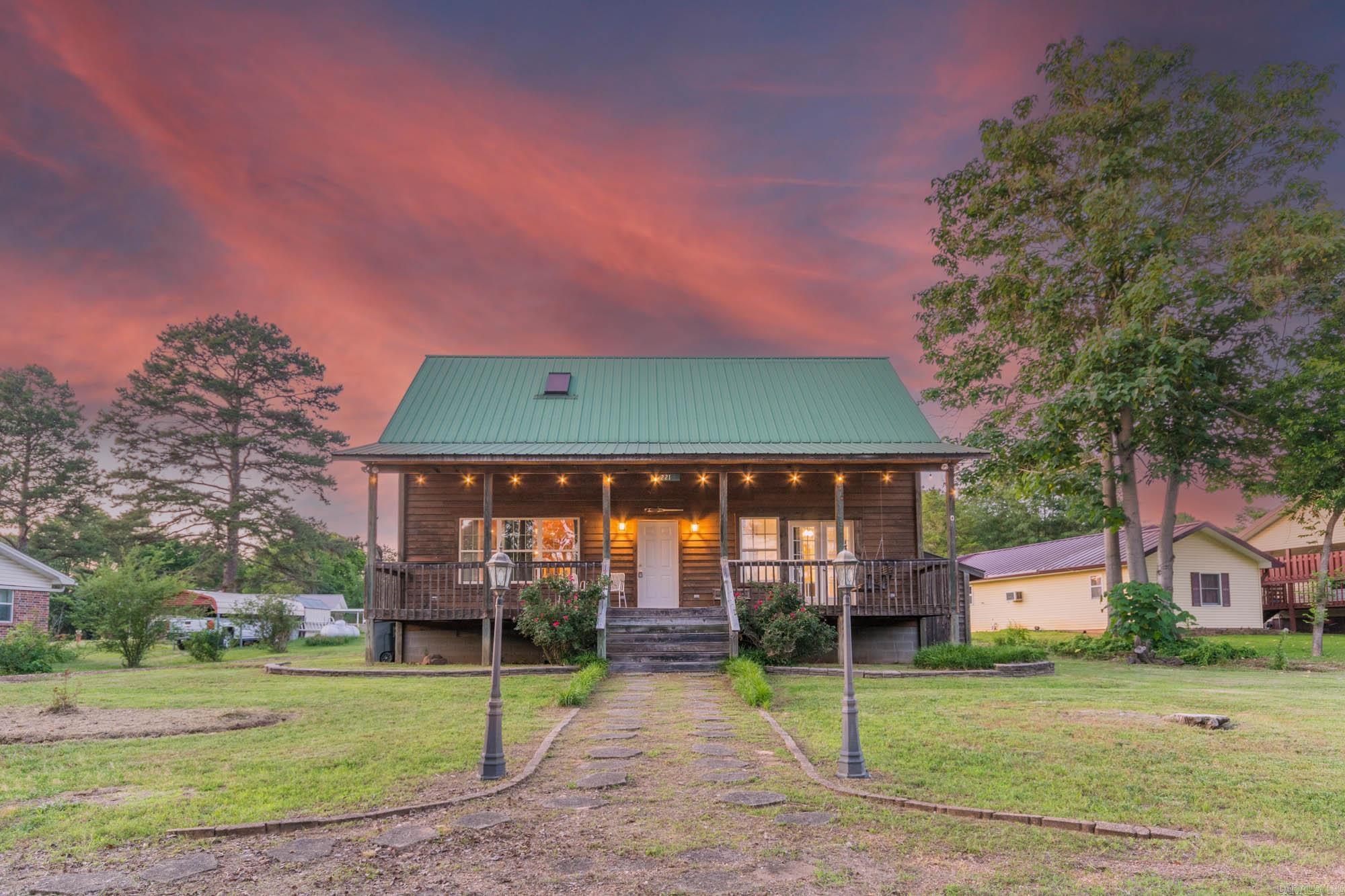 Own a lake house that pays for itself! This fully furnished, 3-bedroom, 2-bath cabin with game loft is a rare turn-key opportunity for investors or second-home buyers. This charming retreat has grossed $30,000 in just 10 months of short-term rental operations and is on track for $40,000+ annually. With 56 five-star reviews, it’s an Airbnb guest favorite and ready to continue generating income from day one—with future bookings included. Enjoy lake access with path directly across the road, perfect for boating, fishing, or simply soaking in the natural beauty of Greers Ferry Lake. The home is thoughtfully furnished and equipped to deliver a seamless short-term rental experience or private getaway. The open layout features a spacious living area with vaulted ceilings, a cozy fireplace, and a loft with games and extra sleeping space. Whether you're looking to expand your investment portfolio or secure a vacation property that works for you, this is a rare opportunity to own a performing lake cabin in a prime location. All furniture is included in the listing price. AGENTS PLEASE SEE REMARKS