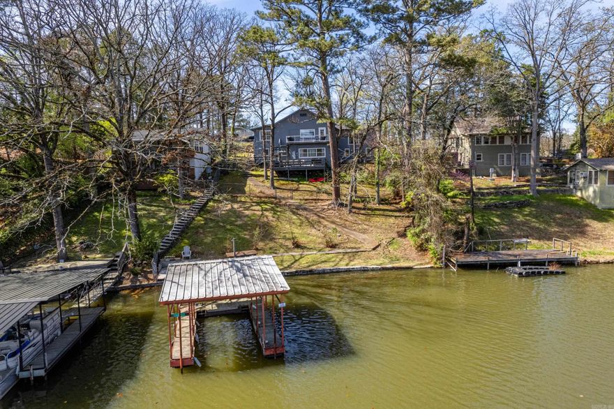 Experience Comfortable Lake Hamilton Living in this Nostalgic Bungalow with Modern Updates! Enjoy Hardwood Flooring and Knotty Pine Wood Ceiling in the Kitchen, a Gas Range, Granite Counters and Breakfast Bar! The Wood Clad Walls and Gas Fireplace in the Great Room create a Cozy Setting for Family & Friends. 2 Bedrooms on the Main Level. One Bedroom on the Lower Level. The Large Back Deck is just off of the Kitchen and likely where you will Spend Afternoons and Evenings, taking in The View and Gathering with Your Favorite People! Or Walk Down to the Dock and Hop on your Boat for All Day Fun! Great 7 South Location (walk to Sam's Pizza!) and Close to ALL Hot Springs has to Offer!