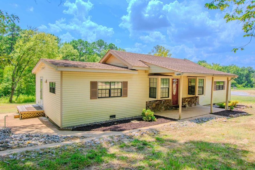 Here's a great opportunity to purchase a home with 1.48 acres of land in the Harmony Grove School District, outside the city limits with no known restrictions.  This 3 bedrooms, 2 bath home includes all appliances (fridge, washer and dryer).  The home is designed where you could install a wood burning stove in the living room.  The living room has two bay windows, and wood decorative beams in the ceiling.  The large eat-in kitchen includes several cabinets for amble storage.  The property features a creek, woods and hill.  The property is sold AS IS.  AGENTS REVIEW REMARKS