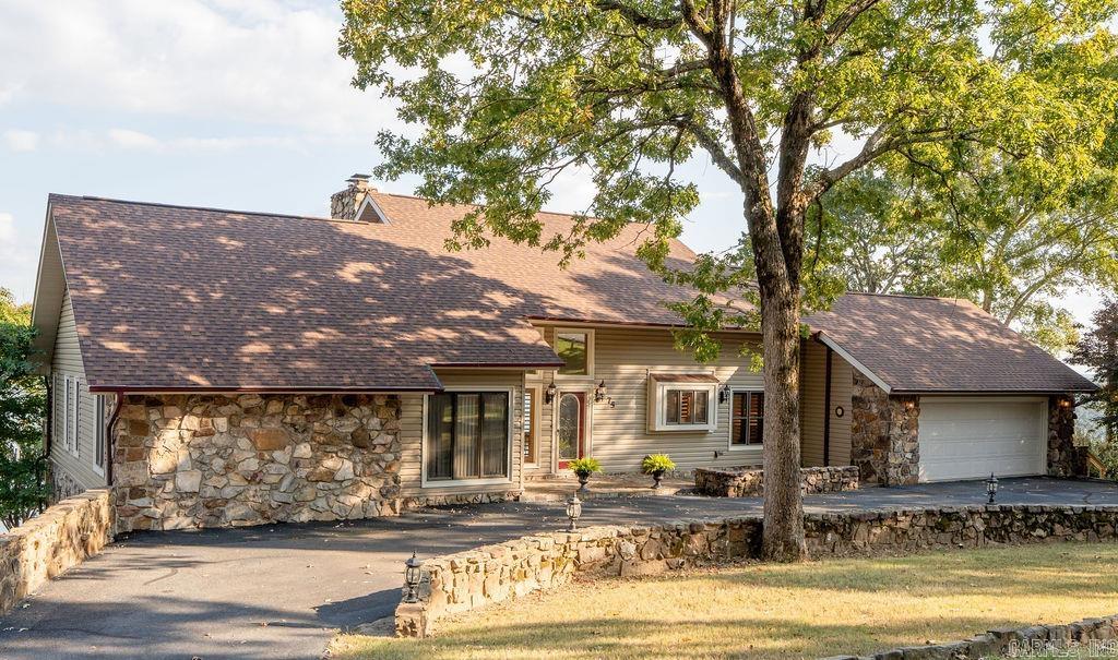 The views of Greers Ferry Lake do not get any better than this! This beautiful property sits on over an acre with extra landscaping that blends perfectly with the natural surroundings, creating a peaceful and private setting. The home features a newly remodeled kitchen offering functional and attractive accent lighting, stainless appliances and gas cook top. A new roof, updated HVAC systems, and a generator panel provide peace of mind and low-maintenance living. Enjoy the well-kept tiled garage with sink and cabinets, in-ground Rainbird sprinkler system, and Wi-Fi-controlled garage door and thermostat. Outdoor living shines with two spacious decks offering incredible lake views—ideal for relaxing or hosting guests. The additional living space/gameroom downstairs is sure to entertain your company with another fabulous view. Beautiful rock detail in the front yard surrounded with a convenient circle drive and an extra parking pad. Wildlife is abundant, making this home a true nature retreat. Whether you’re seeking a peaceful retreat, full-time home, or retirement dream, this lake-view property offers the perfect blend of comfort and natural beauty.
