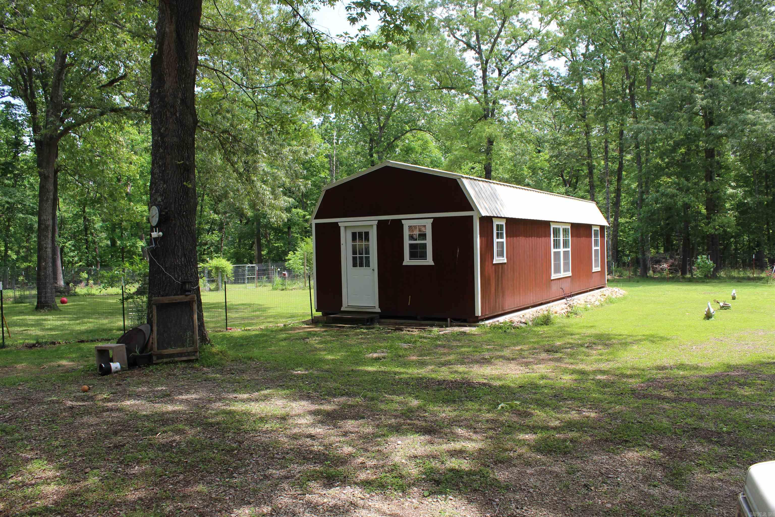 Calling all trout fishermen! This is the perfect fish camp or retirement property. Only 2.3 miles to the Ranchette boat launch on the White River. Private, fenced and gated with separate fenced garden area. Hunting stand by the pond where seller has bagged several deer. Just over 5 acres of usable land. Fruit trees, flowers and wildlife. First cabin is two rooms and a bathroom and second unfinished cabin is newer and has been framed for a bedroom, large bathroom and open kitchen/livingroom with two small lofts for storage. On a well and septic with carport, workshop and cargo container with power.