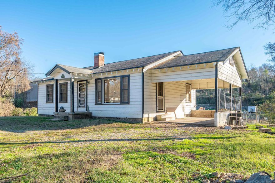City Central and super duper cute cute cute!  Tucked away on approximately 1.44 acres, this 2 bed/1 bath charmer is looking for someone to make it shine even brighter.  Hardwood floors, carport, fireplace.  Refrigerator stays and washer/dryer and furnishings negotiable.  Conveniently located close to Oaklawn, shopping, hospitals, and restaurants.  Great investment property or owner occupy.  Buy it today!