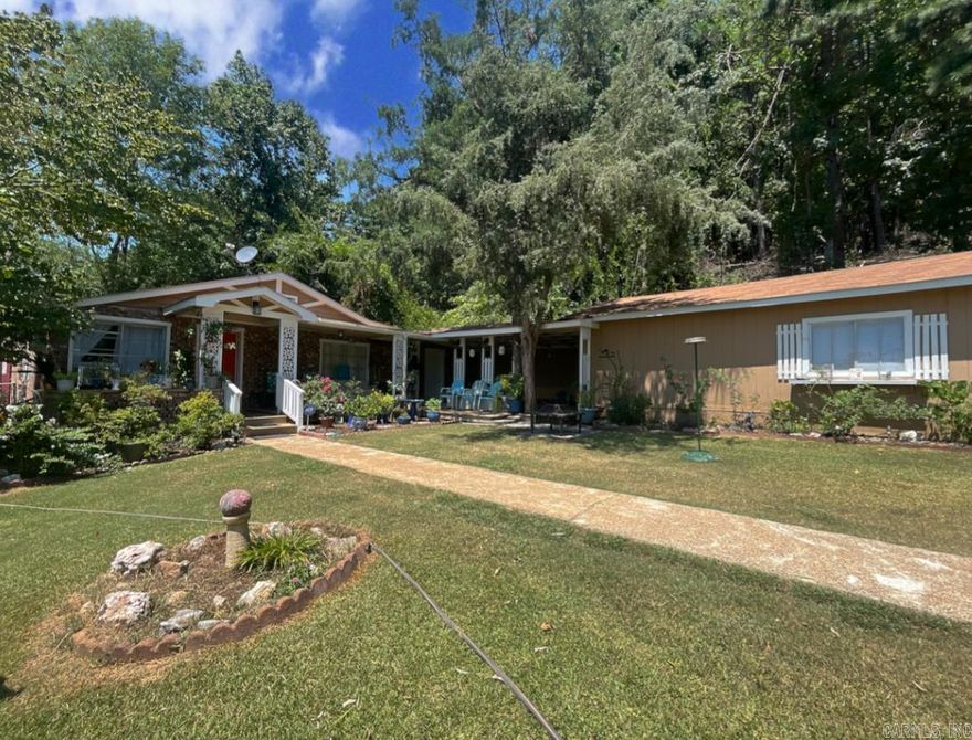 Welcome to this cozy home nestled in the heart of historic Hot Springs! This charming residence offers a serene retreat and is adjacent to the National Park perf for airbnb. Step inside to discover laminate and vinyl flooring throughout, complemented by fresh paint and new carpet in most of the bedrooms. Also, walls are textured sheetrock except in one room, accompanied by new baseboards and molding for a polished finish.The newly updated kitchen features fresh paint, a new sink, and newer appliances, with the added convenience of a walk-in pantry for all your culinary needs.Bathroom fixtures have been updated along with the plumbing. The oversized covered porch invites you to relax and enjoy breathtaking views of nature, providing the perfect spot for morning coffee or evening relaxation.  Outside, you’ll find two chain-link fenced areas, perfect for your dogs to run and play freely. A she shed, workshop, and garage offer versatile spaces for hobbies and storage. Plus, the roof is only three years old, ensuring peace of mind for years to come. This home truly has it all – space, style, and location. Don't miss your chance to own a piece of Hot Springs history with newly updates.