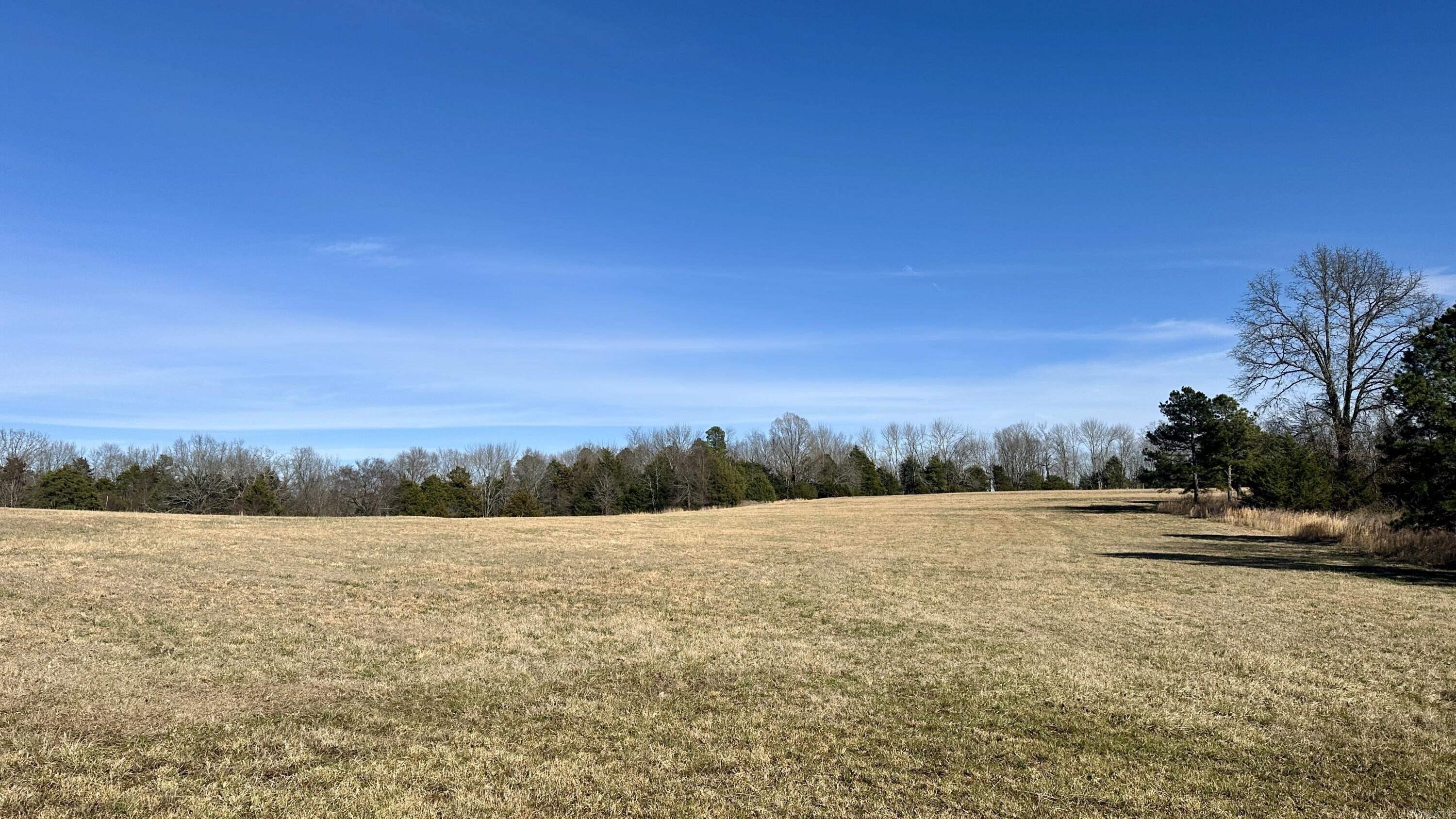 Stunning 25-acre property nestled between Searcy and Rose Bud, Arkansas. This tract offers a mix of open fields and wooded areas, providing a perfect blend of beauty and seclusion. Key Features: • Diverse Landscape: Well-maintained fields alongside wooded draws and hillsides, ideal for outdoor activities and nature lovers. • Ideal Building Spot: There’s a prime location overlooking Murdough Hollow, with Little Creek flowing through, offering a picturesque setting for your dream home or cabin. • Accessible and Private: With county road frontage, accessing the property is straightforward, yet its size ensures plenty of privacy. Location Highlights: • Nearby Towns: The property is approximately 15 miles from Searcy, which offers shopping, dining, and healthcare facilities. Rose Bud, about 7 miles away, provides a small-town atmosphere with essential services. Potential Uses: This property is ideal for those seeking to build your dream home, hunting, or simply enjoying natural surroundings. The varied terrain offers a lot of options for creating your personal haven.