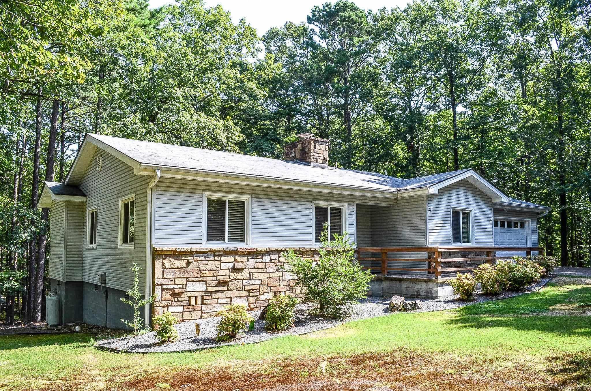 The perfect design for easy living...2 bedrooms and an office plus an Arkansas room. Nice large deck overlooking wooded privacy. This is a Cooper "Villager lll" floor plan. One of Cooper Homes popular styles. Stone wood-burning fireplace has been converted to gas logs, kitchen counters have been updated and fuss free vinyl siding has been installed. Located on a corner lot on a quiet culdesac, this would make a great place to call "home". No property disclosure.Hot Springs Village Property Owner Association has a new member buy-in fee of $2,000.00 due and collected at closing.