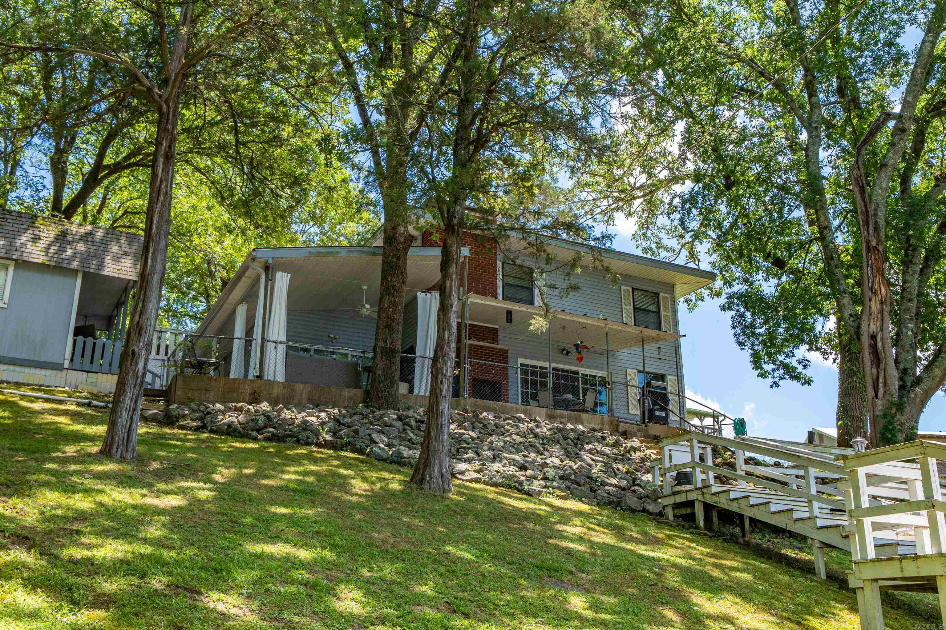 Charming Lakefront Cottage with TRIPLE Covered Boat Dock & Bunkhouse! This beautifully updated light-filled cottage offers the perfect blend of cozy charm and spacious living. With plenty of room to spread out, this home is ideal for both weekend getaways and full-time lake life. Enjoy the rare luxury of a triple covered boat dock, perfect for all your watercraft and lake toys. A separate bunkhouse with half bath adds extra sleeping space or can be used for storage, hobbies, or guests. Inside, youāll find tasteful updates throughout and a home that has been lovingly maintained. This is lakeside living at its finestāmove-in ready and waiting for your next adventure! Oh and updated electrical so you can add three mini splits if you want to! AGENTS please see notes for more details.