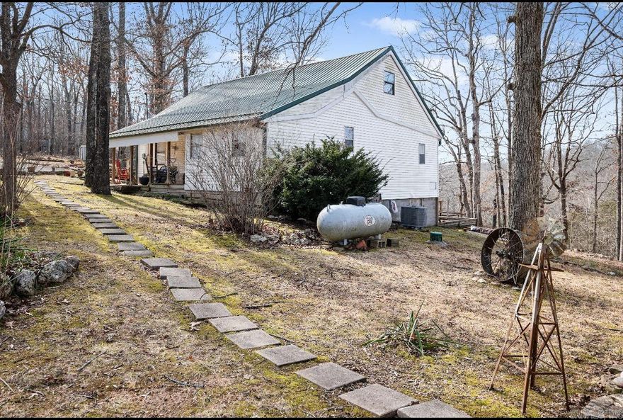 This beautiful country home is a dream retreat for anyone who loves nature and tranquility. Nestled on 10 +/-secluded acres with a creek, it offers a perfect blend of privacy and natural beauty. The 360-degree views from the home provide a nice view of the surrounding landscape, making it an ideal spot for birdwatching, wildlife observation, or simply soaking in the serene environment. Stepping inside, you're immediately greeted by a warm and inviting atmosphere. The parquet floors and nice staircase serve as a focal point, while the spacious living room provides a comfortable space to unwind.The kitchen is a country cook's dream, with ample  space for preparing meals and a dining area that offers plenty of shelf space.The home also boasts an abundance of storage options, including a room that wraps around to the front porch. The primary bedroom, located on the bottom level, is generously sized, while the upstairs features two additional spacious bedrooms. For those who love the sound of running water, the creek is just a short walk away.   If you're looking for a home that combines rustic charm, peace and privacy, you will not want to miss out on this country home! Call today !