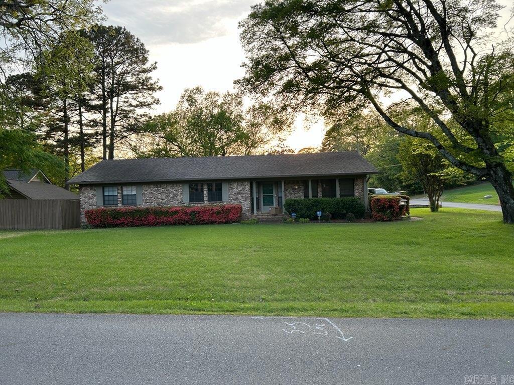 Move-in ready! This charming 3-bedroom, 2-bathroom lake home offers 1851 sqft+\- of classic appeal in the Sherwood Forest subdivision. Ideal for a large family, it boasts a fenced backyard on a corner lot. The interior is filled with natural light and features a fully equipped, stylishly updated kitchen with Stainless appliances, fireplace with antique mantel, dining room, a jetted walk-in tub, and instant hot water and a stackable washer/dryer in primary en-suite. New flooring throughout most of the house, Generac Generator, Levona Home Scent Diffuser system, and a double car garage. Relax and entertain on the inviting back deck that overlooks Lake Hamilton. Tie up your boat and watch the holiday fireworks from your own boardwalk. Centrally located with convenient access to everything you need.