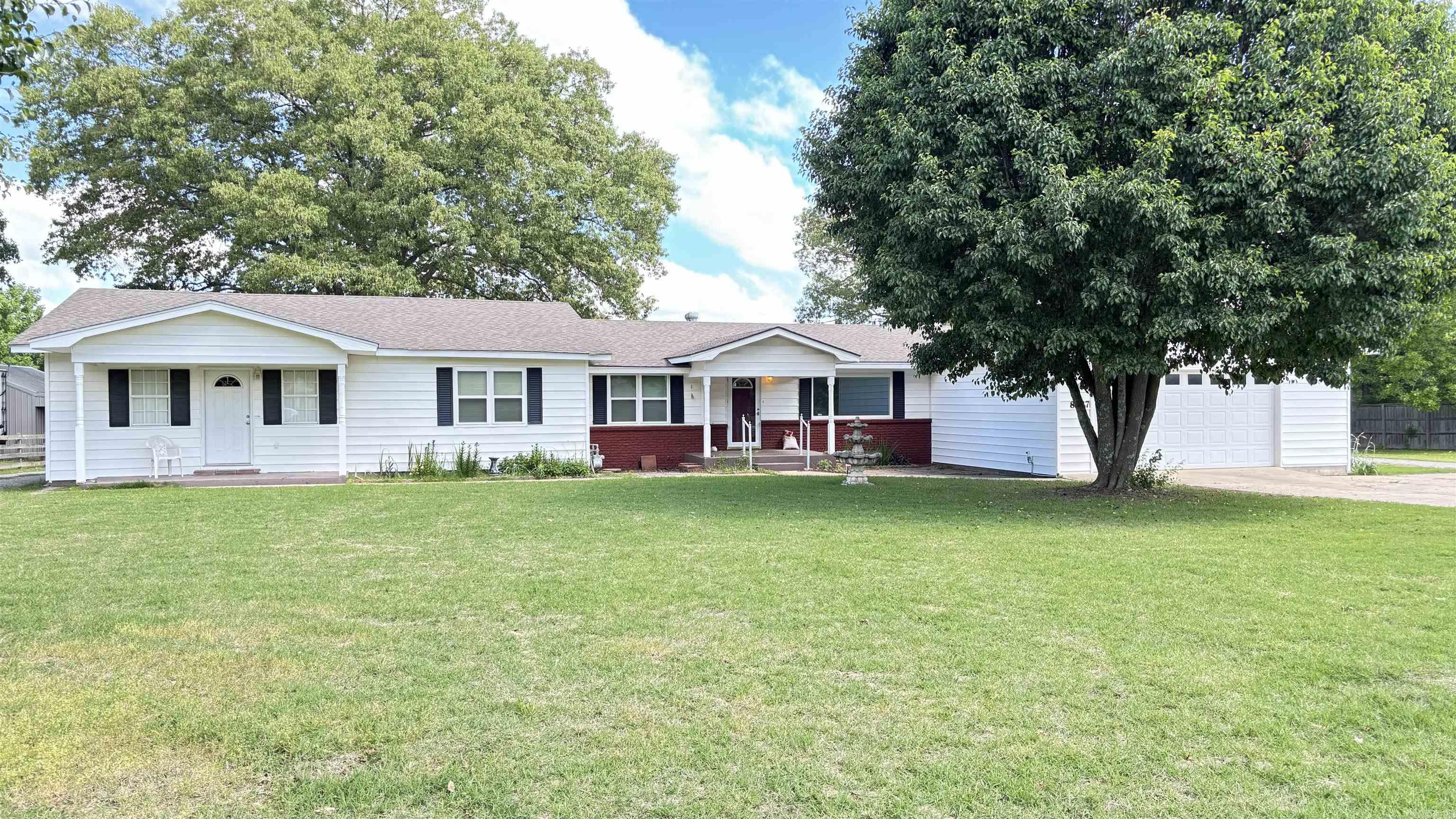 TWO HOMES !!! If you have a need or desire for 2 homes with independent living quarters, you've landed! Each homes has it's own kitchen, bedrooms, living areas, bathrooms, utilities, laundry area, parking and entrances! The main home has 2763 sf of heated and cooled space with a two car garage. The primary bedroom is large enough for oversized furniture and could accommodate a modest office space and sitting area. The primary bath is equally proportioned with double sinks, separate tub and shower and space to move about. A huge game room complete with pool table is also a room with varied and flexible uses. A fully equipped kitchen, a living room, 2 additional bedrooms, laundry room and walk-in pantry complete this home. The guest house has 1026 sf, 2 BRs, 2 BA, a kitchen with lots of countertop space and cabinets, living room and laundry hook-ups . This home has it's own driveway and carport also! A 980 sf shop and a 10x12 storage building are also on the 1 acre grounds. The shop has 2 overhead doors and is mostly open except for a wall that was constructed for sectioning off a small once occupied living area. The acre is level and is not in a subdivision! See agent remarks