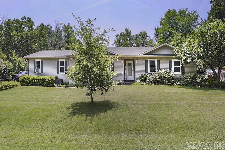 This is the house you have been waiting for in Saline County! House sits on 2 lots (1 acre) moments from I-30 and Benton and Bryant. This great house offers a large living area with a wood-burning fireplace and plenty of room for multiple sitting areas. The kitchen is large with newly painted cabinets (lots of storage), glass tile backsplash and room to entertain. The large master features newer tiled shower, large walk-in closet, and lots of light. House has been newly painted and features hard flooring throughout. Over-sized 3 car garage offers plenty of room for a shop setup. Large backyard with patio makes this the perfect home! Call today! Hot Water Heater: 2015 HVAC: 2017