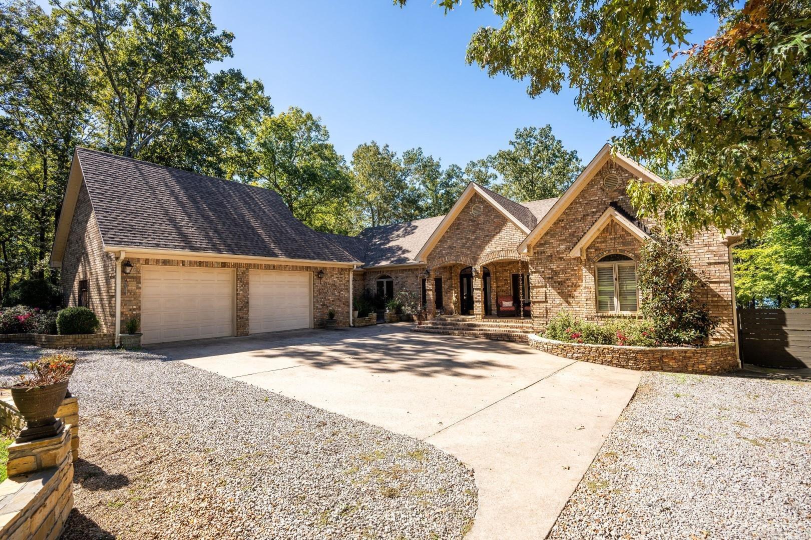 Elegant Lakefront Retreat on Greers Ferry Lake! Enjoy stunning sunsets in this lovely 3-bedroom, 3-bathroom residence! Nestled right on the shores of Greers Ferry Lake, this property offers an unparalleled lakefront location and a golf course within a 2-minute walk! Step inside to find soaring tall ceilings complemented by exposed beams, creating a warm and inviting atmosphere. High-end travertine flooring with Pella doors and windows that flood the spaces with natural light. The master suite, with lake views, is a true sanctuary, boasting a luxurious en-suite bathroom equipped with a shower and a jetted tub. Multiple living areas provide ample space for entertaining or cozy family gatherings...plus an additional office/workout room downstairs. Wet-bar, laundry room with sink, double-sided fireplace, wooden ceilings, barrel ceiling in dining, plenty of storage, 2-car garage, multi-level back deck. Roof is less than 5 years old, all 4 HVAC units are new in the last 4 years...the full-time residents have taken great care of the property!