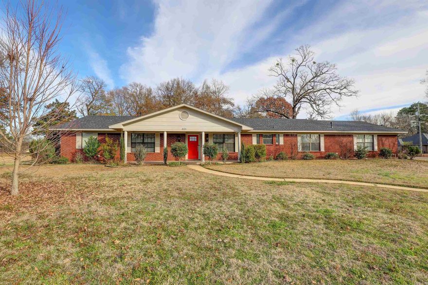 Welcome to 221 Bell Ave., Texarkana, AR – a beautifully updated 3-bedroom, 2.5-bath brick home on 1.03 acres. This one-story gem features vinyl and tile flooring, fresh paint, and spacious rooms throughout. The large family room boasts a converted gas log fireplace, while the open kitchen offers ample storage and a sizable breakfast area. French doors lead to a formal dining room or office. Enjoy outdoor living on the covered patio with tile flooring. The master bedroom is a retreat with an en suite and his/her closets. Experience modern comfort in a classic setting at this charming property.