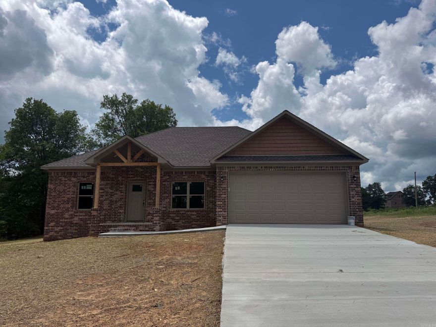 Brand new construction with modern style and thoughtful design! This 3-bedroom, 2-bath home features an open-concept layout with a spacious living area, soaring vaulted ceilings, and abundant natural light. The kitchen is designed for both function and style with a large island, custom cabinetry, and ample storage space—perfect for entertaining or everyday living.  The private primary suite offers a relaxing retreat with a double vanity and a walk-in shower. Secondary bedrooms are generously sized with easy access to a full guest bath. Quality finishes throughout include recessed lighting, clean lines, and a neutral color palette.  Enjoy the durability of a full brick exterior, a 2-car garage, and a peaceful setting with room to spread out. Don’t miss this chance to own a beautiful new home soon to be completed!