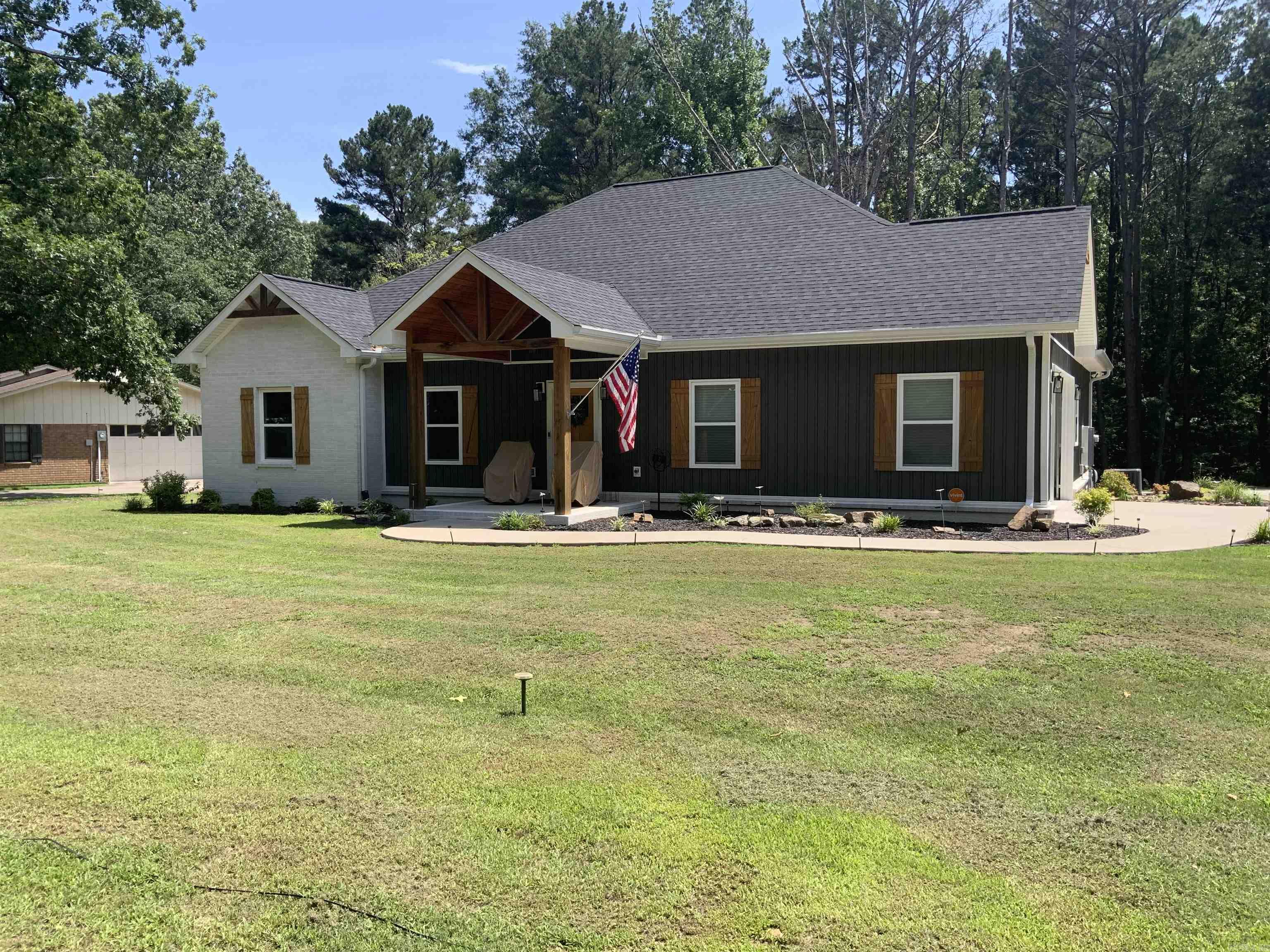 This exceptionally well kept 3 bedroom 2 bath home sitting on almost an acre is a farmhouse /craftsman style home with beautiful white brick and stained wood accents with gorgeous landscaping all around it. The interior features an oversized living room with vinyl plank flooring. The Quartz counter tops stand out along with the custom tile. The primary suite exhibits a spacious area to accommodate large furniture and the primary bath has a walk in shower and separate soaking tub. This home is exquisite and a must see. Call to schedule your showing today