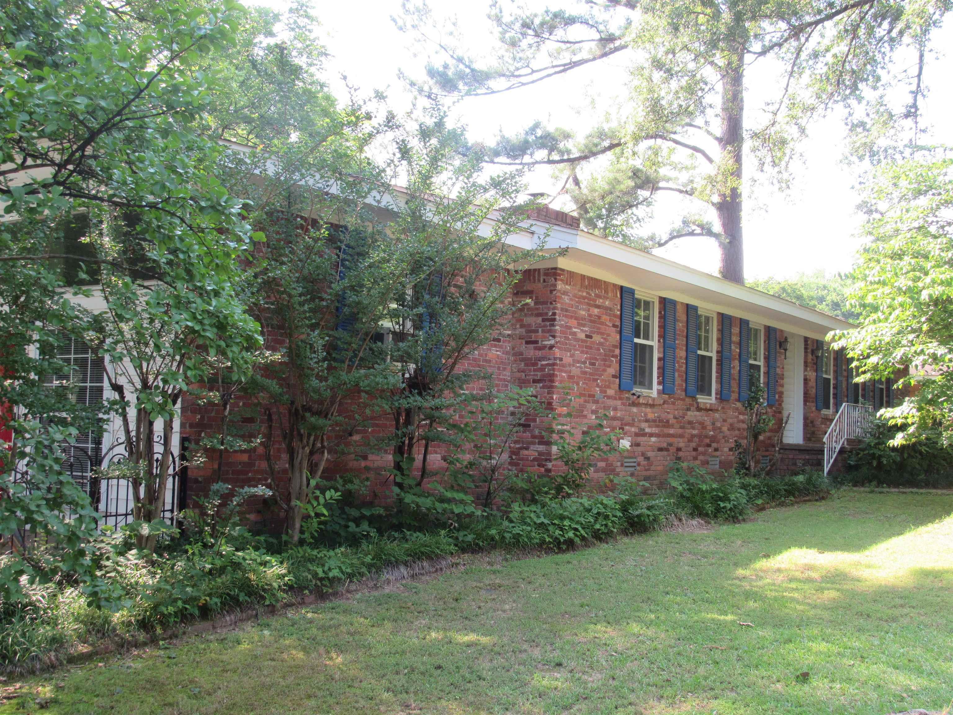 The flexible floorplan on this home affords you privacy while also giving you several areas to entertain. Several multi-use rooms to fit your lifestyle. Enclosed garage is heated and cooled with a mini-split and can be returned to a garage very easily. There is a huge walk-in closet with shelving off this room. On the back of the house is a spacious sunroom with a mini-split for heat and air and a gas wall heater for backup heat in a power failure. Large living room as you enter the home and a den/dining room off the kitchen. In the past few years seller has added some laminate flooring, new wall oven, new faucet and sprayer in kitchen. Electrician replaced all outlets and switches. Fireplace in den was converted to gas logs. Wood shutters instead of blinds in most rooms.