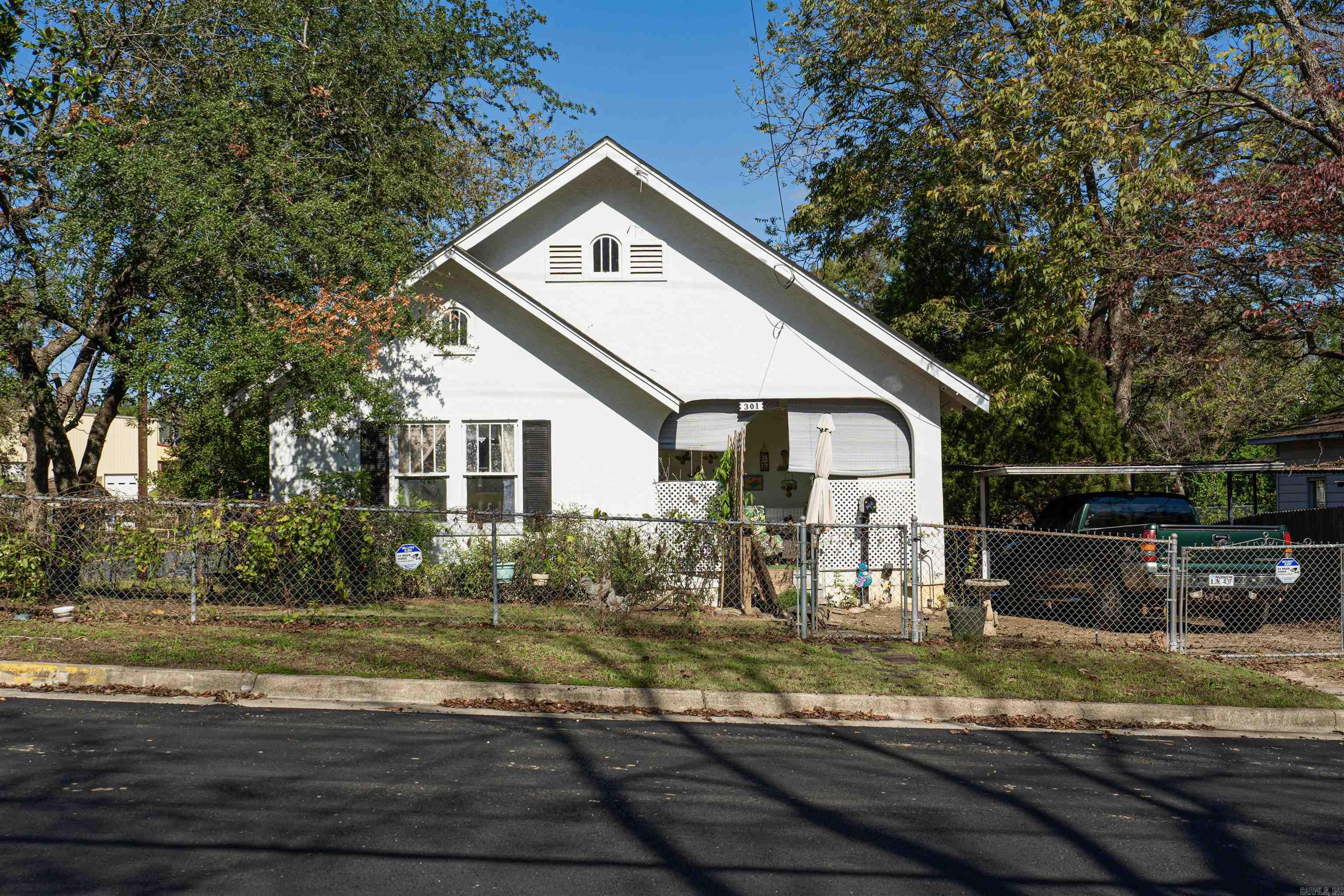 Welcome home to this cute, cozy, 2-bedroom, 1.5-bath home. Nestled in the heart of Hot Springs, this home features hardwood flooring throughout and tile-finished bathrooms for a seamless blend of charm and practicality. With warm, neutral paint throughout, this home feels bright and inviting from the moment you walk in. The spacious kitchen provides plenty of storage and ample counter space, ideal for meal prep and gatherings. Outdoors, a covered carport and charming front porch create additional spaces to enjoy, while a chain-link fence surrounds the property for added security and privacy. Property is being offered "AS IS". Seller will not make any repairs. Located minutes from Hot Springs’ vibrant downtown, this home is ideal for anyone looking for a cozy retreat with easy access to the city’s best dining, shopping, and entertainment. Schedule your private tour today!! AGENT REMARKS