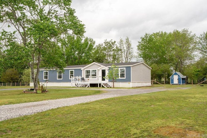 Built in 2021, this home, set on a PERMANENT FOUNDATION, offers bright, open living spaces with a well-designed, functional layout. The kitchen features a large island and walk-in pantry and opens to the main living area. The second living area also comes off of the kitchen and provides added flexibility.    The split floor plan includes four bedrooms, each with a walk-in closet. The primary suite features a spacious bathroom with a tiled shower and freestanding tub, while the second bathroom offers a sink area, which can be closed off from the shower area for convenience.   Situated on 1.53 acres, the property includes a circle drive, fully fenced backyard, and two storage buildings, as well as some fun extras, such as strawberry and blueberry bushes.  In addition to the features mentioned above, the home was thoughtfully designed with accessibility in mind. Not only is it one-level, but it also includes other details, such as exterior ramps, and wider three-foot doorways.   Don't miss your opportunity to own this beautiful property! Schedule a tour today!