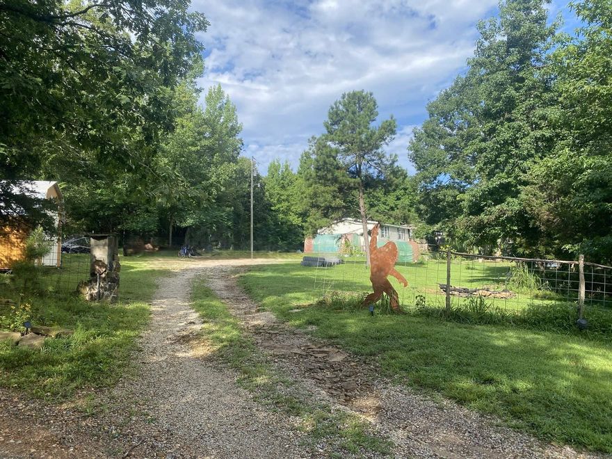 Nestled near Mountain View, Arkansas, this property boasts a serene setting perfect for those seeking a peaceful retreat. This property features a large mobile home in excellent condition, offering 4 bedrooms and 3 bathrooms for comfortable living. The primary bedroom has a large garden tub, a separate shower, and a large walk-in closet. The kitchen is updated with a new cabinetry and refrigerator in the last 3 years. The home also features a separate dining room and two living room seating areas.  The grounds have lighting lining the many walking paths and in the trees  to make the area look like a park at night. An abundance of various garden containers and beds meant for those that love to play in the dirt!  Cool off on those hot summer days in the above-ground pool.  Hang your hammocks and relax underneath the trees. Jump in a kayak in the pond. Or just sit and listen to all of the wildlife! The property is partially fenced ready for animals. There is a chicken coop out the front waiting for your flock!  There is additional fencing not installed that will convey with the property. The new 10x20 shed gives room for storage. The covered front porch has room for a grill and more!