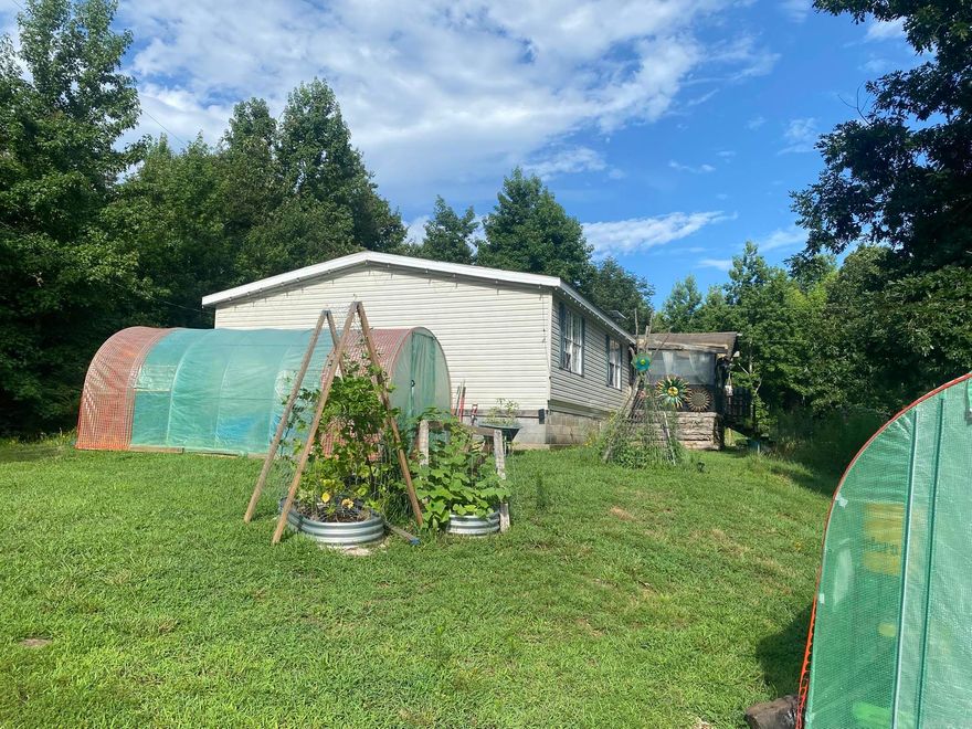 Nestled near Mountain View, Arkansas, this property boasts a serene setting perfect for those seeking a peaceful retreat. This property features a large mobile home in excellent condition, offering 4 bedrooms and 3 bathrooms for comfortable living. The primary bedroom has a large garden tub, a separate shower, and a large walk-in closet. The kitchen is updated with a new cabinetry and refrigerator in the last 3 years. The home also features a separate dining room and two living room seating areas.  The grounds have lighting lining the many walking paths and in the trees  to make the area look like a park at night. An abundance of various garden containers and beds meant for those that love to play in the dirt!  Hang your hammocks and relax underneath the trees. Jump in a kayak in the pond. Or just sit and listen to all of the wildlife! The property is partially fenced ready for animals. There is a chicken coop out the front waiting for your flock!  There is additional fencing not installed that will convey with the property. The new 10x20 shed gives room for storage. The covered front porch has room for a grill and more!