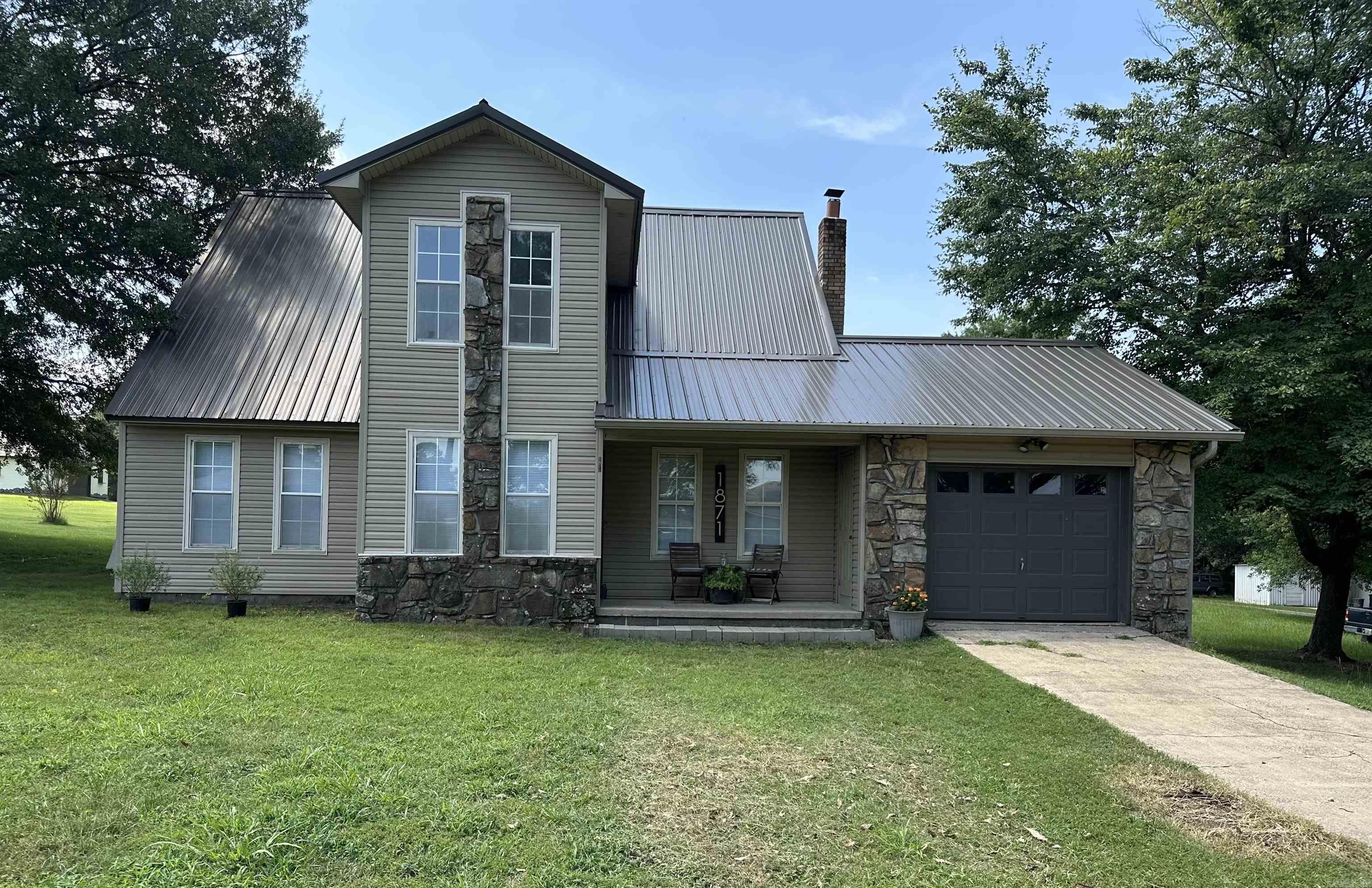 A MUST SEE! Contemporary Farmhouse with Rustic Charm! Step into this beautifully updated home featuring fresh paint, brand new lvp flooring and designer carpet (June 2025), metal roof (April 2024) and new dishwasher (July 2025). This unique property blends modern convenience with rustic appeal, offering a spacious covered back porch perfect for evening relaxation, private setting on ample 1.48 acres, and a storm shelter for peace of mind. You'll also appreciate the covered exterior storage and the distinctive floor plan that sets this home apart Located close to many amenities, yet nestled in a quiet setting - it's the best of both worlds!