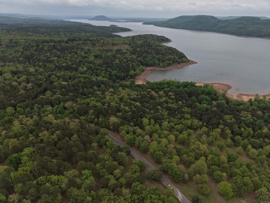 GREERS FERRY LAKEFRONT LOT Large lot with over 750 feet of white line in Burnt Ridge Estates subdivision. 3.95 Acres with underground utilities and an easy walk to the water.  A boat launch is located in the neighborhood, and you are just minutes to Choctaw Marina or Fairfield Bay by water.  This lot is located between Harper's Cove on Southfork to the West and Party Cove to the East. Bring your plans, build your dream and enjoy the lake. Realtors See Remarks