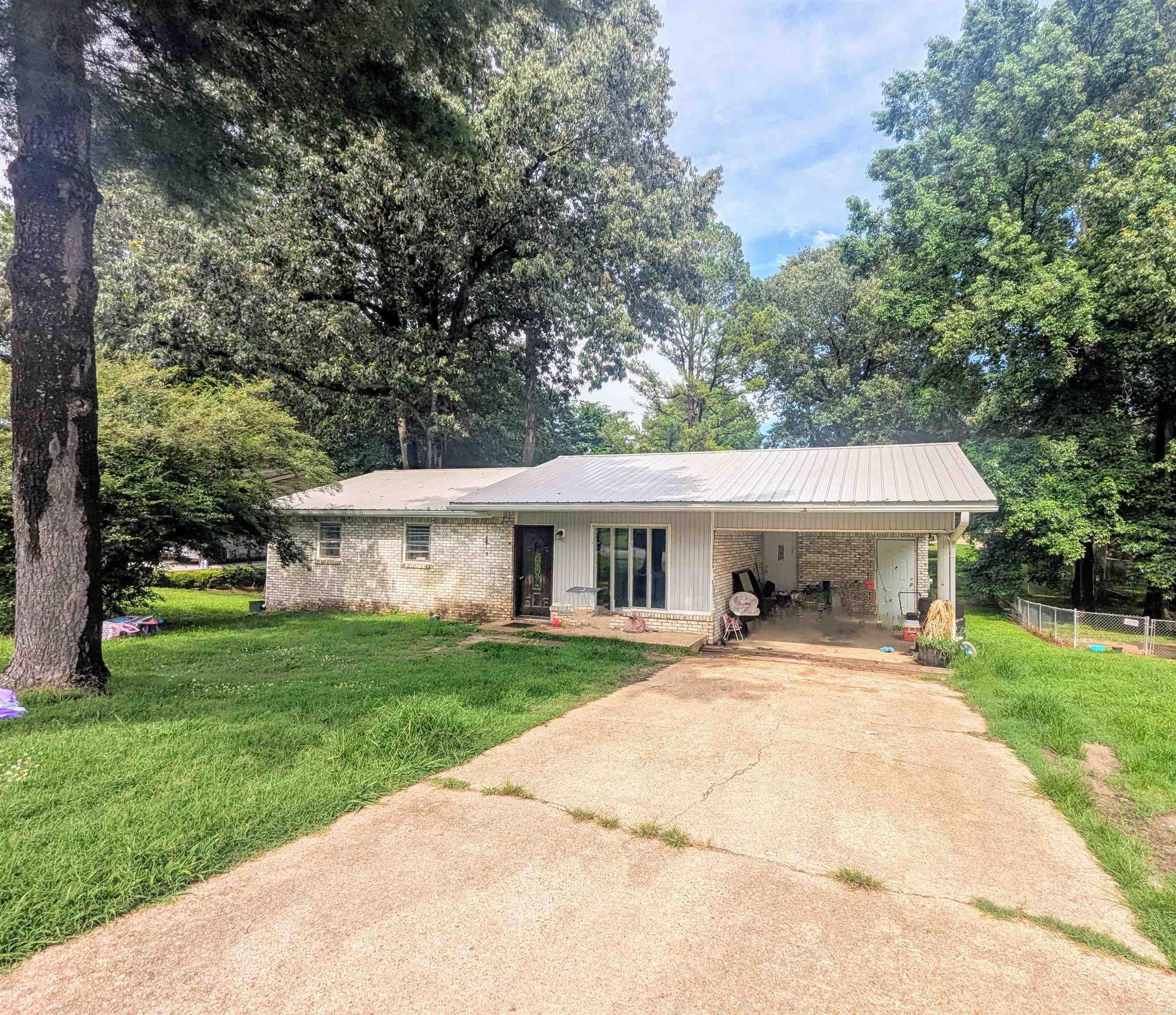 Take a look at this adorable brick home in a great location, just walking distance to the park! This home offers a low-maintenance metal roof, spacious yard and carport for covered parking. A cute home that's also affordable, you'll want to set up a time to come see this one today!