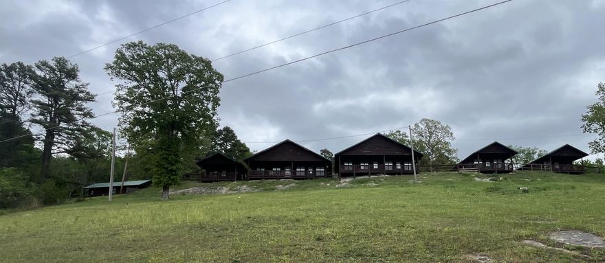 Exceptional turn-key nightly rental opportunity overlooking the White River in beautiful Mountain View, Arkansas. This established hospitality property includes 6 rental units: 1 efficiency unit, 3 cozy one-bedroom/one-bath cabins, and 2 large four-bedroom/three-bath cabins designed to accommodate larger groups and families. The one-bedroom and four-bedroom units offer full kitchens with stove, refrigerator, and microwave, while the larger cabins feature a whirlpool tub in one of the bathrooms for an added touch of comfort. Recent improvements include new bedding, mattresses, and televisions, helping make this property guest-ready from day one. Currently marketed through Evolve, this is a ready-to-go investment opportunity in one of North Arkansas’s most desirable tourism areas. Financial records available upon request.