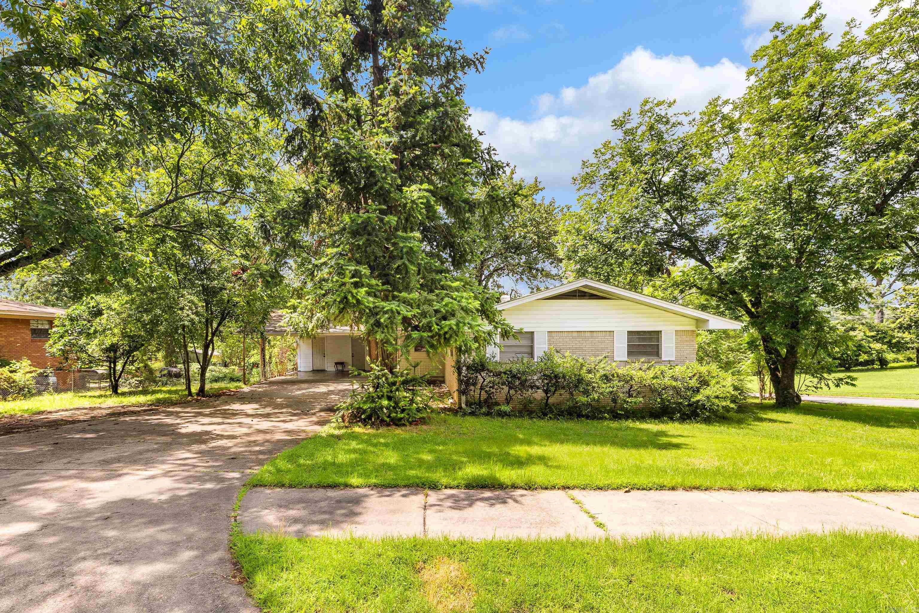Beautiful home on a corner lot in a well-established neighborhood. Walk into an open living room with gorgeous hardwood floors throughout most of the home. New paint and fixtures throughout, along with updated counters in the bathrooms with updated fixtures. Additional storage is also accessible in the carport.
