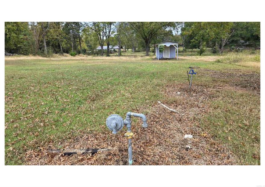 Cleared lot in Lamar with public water and natural gas at the street. Easy access to US-64 and I-40. It is just over an acre according to the tax record. There is a storage building on the property. AGENTS: see MLS remarks for offer information.
