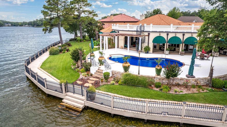 RARE! This is your chance to own a luxury home located on the tip of Ard Pointe subdivision. This stunning Mediterranean style home offers 3551 sq. ft. Located on a level point with 246' of lake frontage. Open living concept w/exceptional lake views of the main channel. Beautiful craftsmanship throughout, custom cabinets, granite countertops, elevated ceilings with crown molding, tile, hardwood floors and marble flooring in master bathroom. Home office area, Whole home generator, Gas fireplace, Man cave/Media room, Saferoom, Whole home intercom system. Salt water pool. Covered boat dock with two slips. Wave runner slips do not convey.  Three car garage