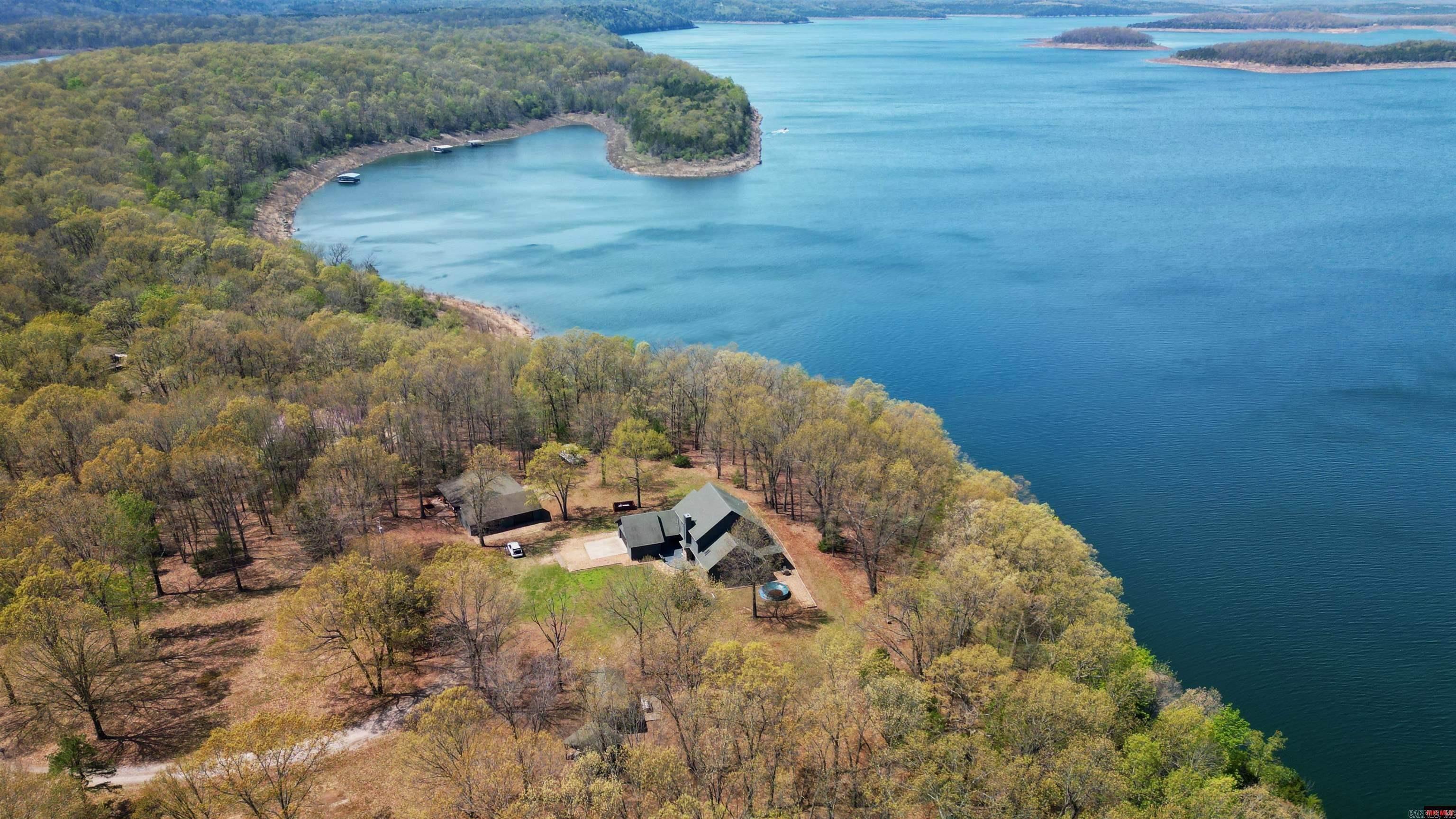 Looking for your own slice of heaven? Welcome to this stunning lakeside estate on 3 acres m/l with end-of-the-road privacy and incredible access to Bull Shoals Lake! This one-of-a-kind 4-bedroom, 31/2-bath beauty offers over 5,000 sq ft of comfortable, spacious livingāperfect for hosting, relaxing, or just soaking in the good life. NEW roof June 2025! Step inside and head down to the basement, where you'll find a custom-built bar and a huge open areaāideal for a game room, man cave, or the ultimate kids' hangout. Whether itās movie nights, ping pong tournaments, or weekend parties, this space is designed for fun and entertaining on a grand scale. Step outside and fall in love with the outdoor kitchen, gazebo, covered front porch, and breezeway connecting to a massive 32ā x 40ā covered patio/carportāperfect for lakeside gatherings, summer cookouts, or simply unwinding under the stars. Plus, thereās a 24ā x 40ā detached garage with room for your boat, workshop, or weekend toys.