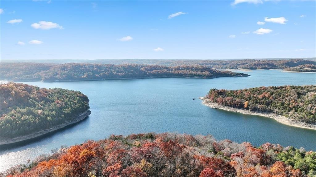 Wow! 71.82 acres of natural beauty with a cozy cabin and 681 feet of lake frontage that is level/gently sloped, on one of the deepest coves on the lake, offering seclusion and easy access to three boat launches! The mostly wooded land features marketable timber and is ideal for hiking, camping, or building your dream lake home. Split the land to recoup investment or simply enjoy the peace! Adjacent Corps of Engineers property ensures more untouched nature. Abundant wildlife thrives here, offering great hunting and fishing opportunities! Rural Water is available, and the 2,560 sq. ft. rustic cabin has many custom features and is built tough with strong 6x6 post construction with southern yellow pine. With 1-foot thick walls, It’s easy to heat/cool! Flooded with natural light, it offers 29 windows on the first floor and 46 on the second, providing beautiful views. Decks: 48'x8' and 12' on the first floor, 8'x24' on the second. If you're primarily looking for acreage, this property can be divided with 60 acres featuring prime lakefront frontage without the cabin, for $686,400!