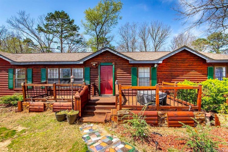 Nice Manufactured home has a log home feel and sits on a permanent foundation will qualify for 30 year mortgage.  Sits on 3.72 private acres of land.  Has a wet weather creek in the back yard. Home is a three bedroom two bath split floorplan. Has 2 living areas. Many updates and upgrades have been completed.  New roof 3 years ago.  Well has just been serviced. Call for more info