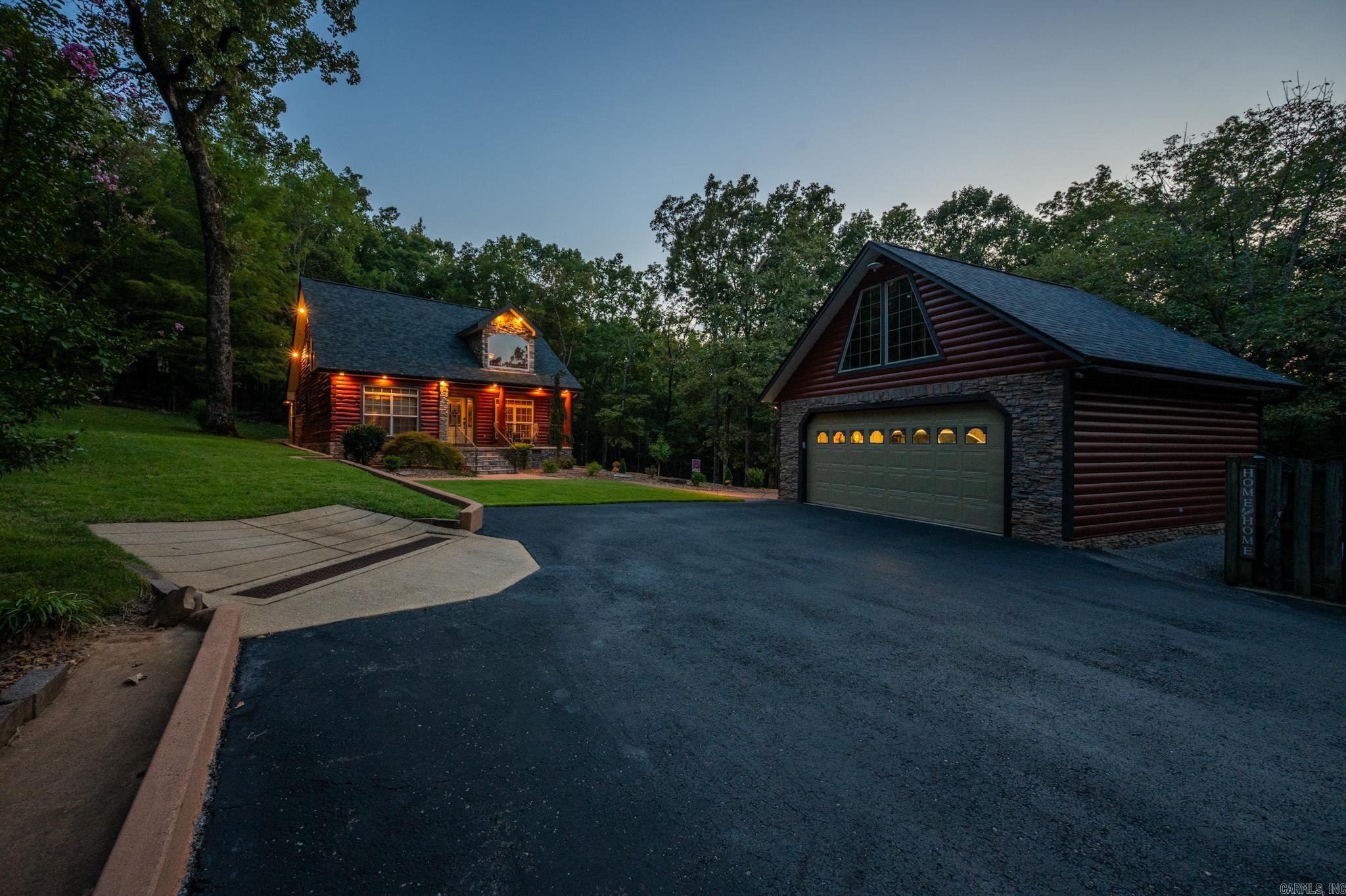 STOP SCROLLING—THIS PROPERTY HAS IT ALL! A BEAUTIFUL LOG HOME on 12.86 m/l ACRES offering PRIVACY, MODERN UPGRADES, and ENDLESS POSSIBILITIES.The est. 1,827 sq ft main home (finished 2006) features 2 bedrooms, 2 baths, a LARGE DEN that could be a 3rd bedroom, soaring ceilings, tall windows, a stunning staircase, and a BEAUTIFUL KITCHEN with gorgeous cabinets, plenty of space, and STAINLESS STEEL appliances. The home feels COZY with abundant NATURAL LIGHTING throughout. Updates include NEW architectural shingles (2024), ENERGY-EFFICIENT well-maintained HVACs, freshly re-stained exterior logs (2025), EXTERIOR DRAINS, CULVERTS, and 400 AMP UNDERGROUND SERVICE for added reliability. Enjoy the BEAUTIFUL LANDSCAPE and unwind on the BACK PATIO. The est. 861 sq ft MOTHER-IN-LAW SUITE has 2 bed/1 bath, newer mini-splits, and its own driveway—perfect for GUESTS, MULTI-FAMILY, or income-producing AIRBNB/VRBO. The 30x40 HEATED & COOLED SHOP with half bath, SOUNDPROOF, and drains is a GAME-CHANGER. The primary home also includes a 2-car garage with power and top storage. At the back of the property, gravel is already in place for BIG MACHINERY, making this home as functional as it is beautiful.