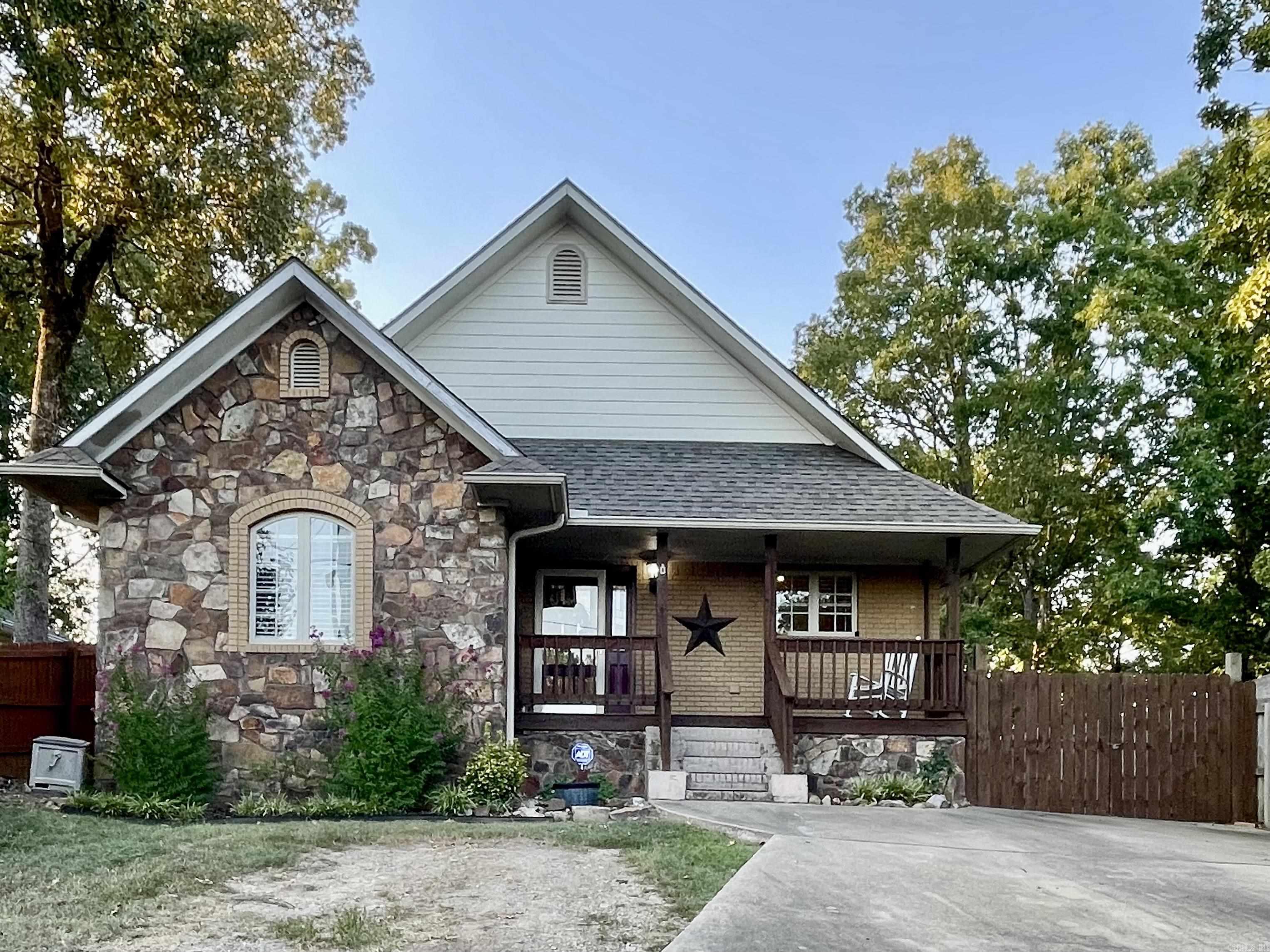 Welcome to this beautifully maintained 3-bedroom, 2-bath home located in the highly sought-after Lakeside School District of Hot Springs. This charming property offers an open and airy layout with vaulted ceilings and hardwood floors flowing throughout the main living areas. The spacious family room, dining area, and kitchen are seamlessly connected, creating a warm and inviting space ideal for both everyday living and entertaining. The kitchen is a standout, featuring granite countertops, a breakfast bar, and a gas stove, perfect for cooking and gathering. The primary suite offers a relaxing retreat with a freshly remodeled bathroom that includes a double vanity, a large walk-in shower, and a separate area for a makeup vanity for added convenience. Step outside to enjoy the expansive deck overlooking a serene green space backyard, offering both privacy and tranquility. Additional highlights include a large storage building, LeafGuard gutters, and a programmable instant water heater to ensure efficiency and peace of mind. This home is move-in ready and situated in one of Hot Springs' most desirable areas, minutes from Lakeside Schools. Donāt miss your chance to make it yours!