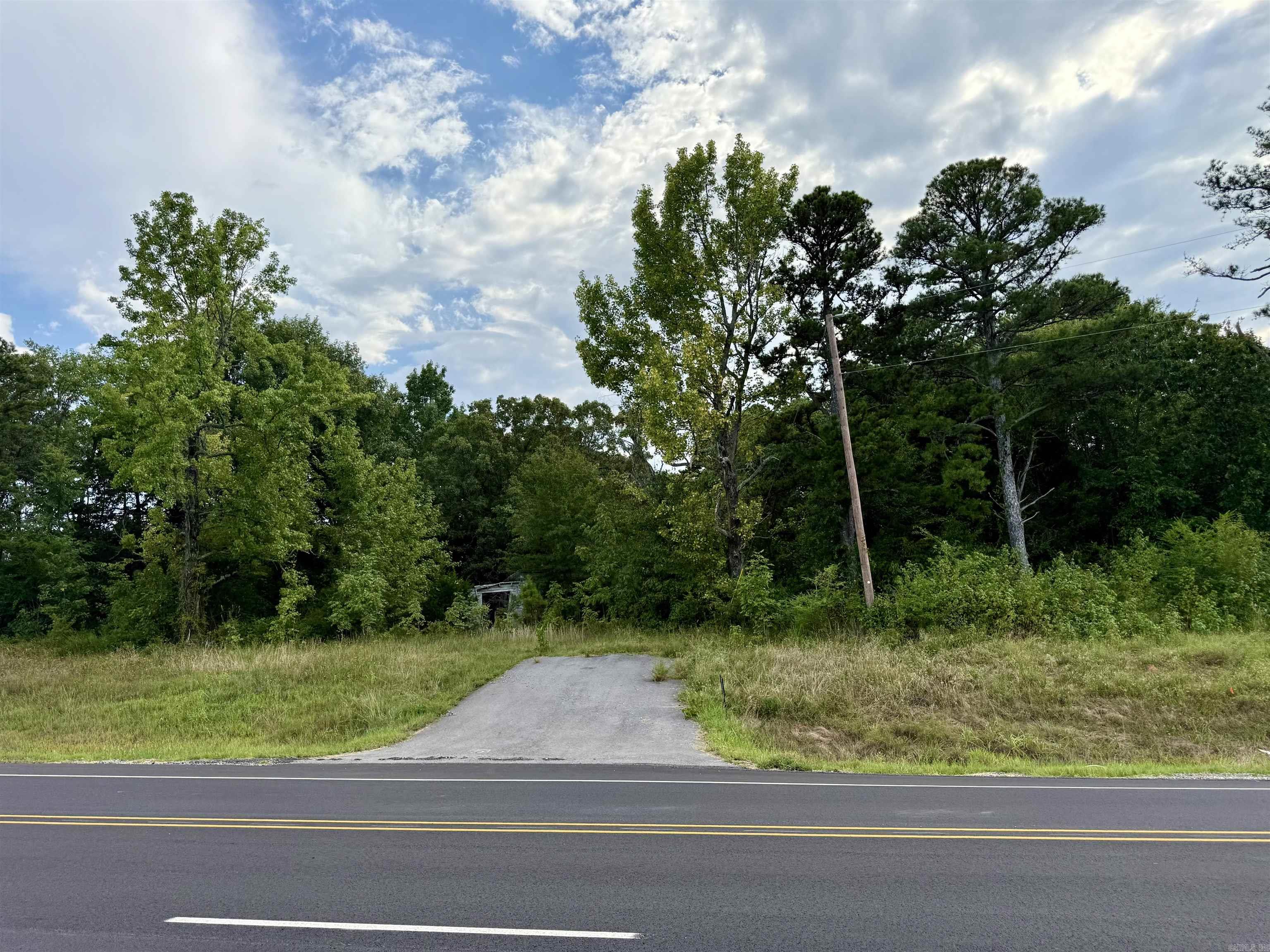 Unrestricted lot, 1.31 to 1.76 acres, more or less. No survey on file. Wooded with drive established from Hwy 16. There is a structure on the parcel, condition is unknown to seller. To be sold AS-IS.