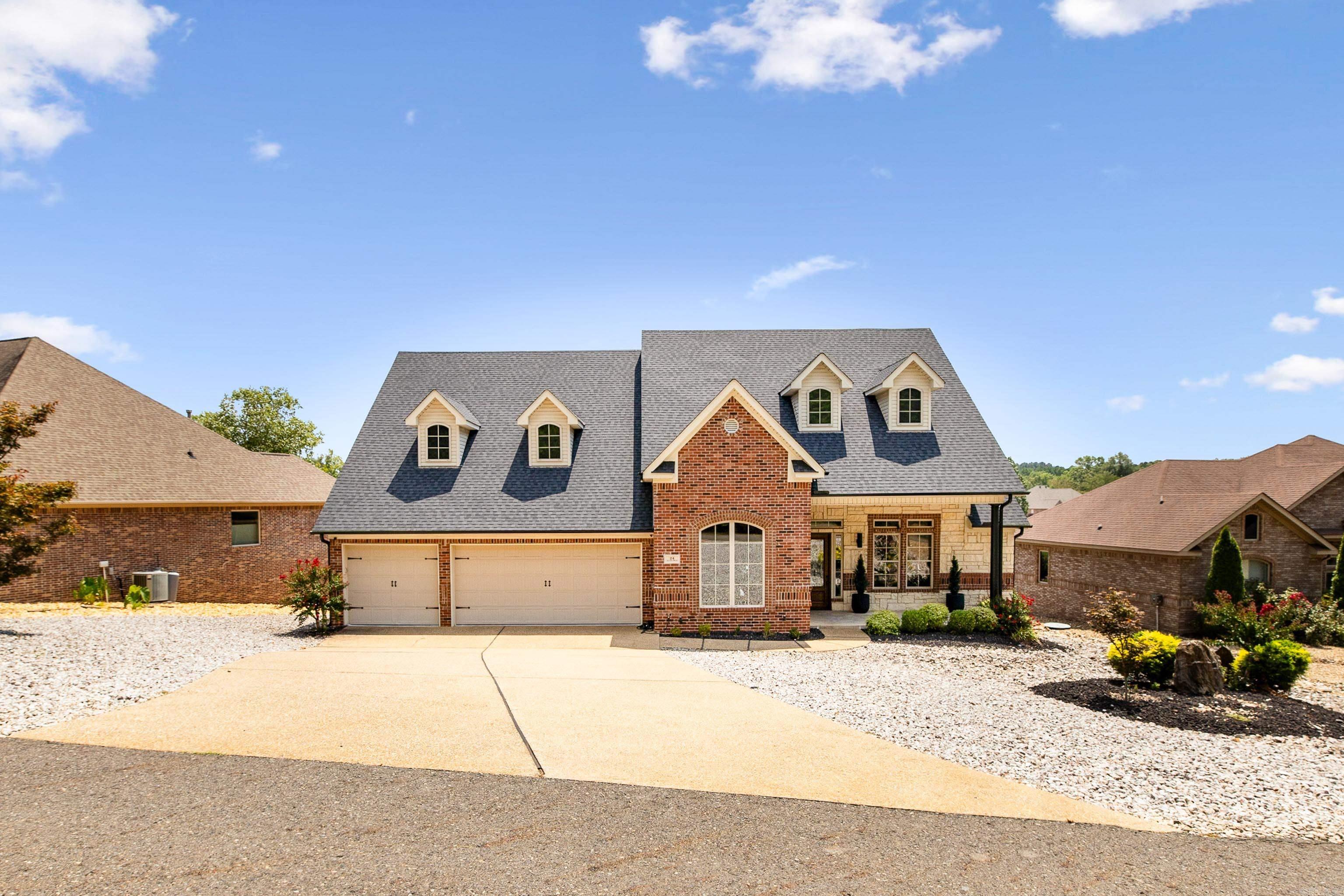 Welcome to this beautifully updated 3-bedroom, 3-bath home on the 8th hole of the Isabella Golf Course in Hot Springs Village. The front entry opens to a formal dining room and an elegant office with wood beams, rich wainscoting, and wood French doors. Layout includes a guest room with hall bath, an en suite bedroom, and two living areas—each with a fireplace. Expansive main living space features tall ceilings and a wall of windows framing stunning golf course views. The kitchen offers a gas stove, double ovens, abundant cabinetry, and recent updates including new lighting, paint, roof, and gutters. The primary suite is a retreat of its own, offering five large windows for unobstructed fairway views, a spacious spa-like bath with a walk-in shower and jetted tub, and a closet with built-in dresser for more storage. Extras include a large floored attic with stair access off living area, a 3-car garage for space for your golf cart, and a 2023 Trex deck—perfect for sunsets and peaceful mornings. Located in the gated community of Hot Springs Village, you’ll enjoy access to multiple lakes, golf courses, and recreational amenities. This is more than a home—it’s a lifestyle.