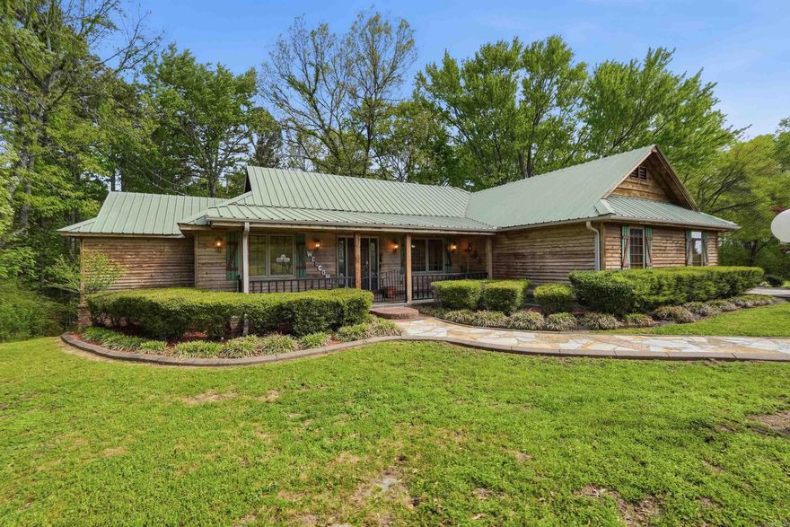 Discover the perfect blend of privacy and convenience with this gorgeous 9.5+/- acres mostly level and cleared with just enough woods for a perfect view. The property includes a 30x30 workshop/detached garage with a 3/4bath and an attached carport large enough for your truck. The lean-to is great extra covered space for implements - plus a 20x40 pole barn and a 10x12 metal shed. The home features a durable metal roof and a spacious floor plan highlighted by beautiful hardwood floors, 2 gas fireplaces, and a large 2nd living area. The generously sized primary suite features a walk-in closet plus 2 more closets. Whether you’re looking for a hobby farm, a primary residence, or a home base with quick access to Greers Ferry Lake recreation areas only 1mile from Dam Site Marina, and close to the Little Red River, this property delivers!