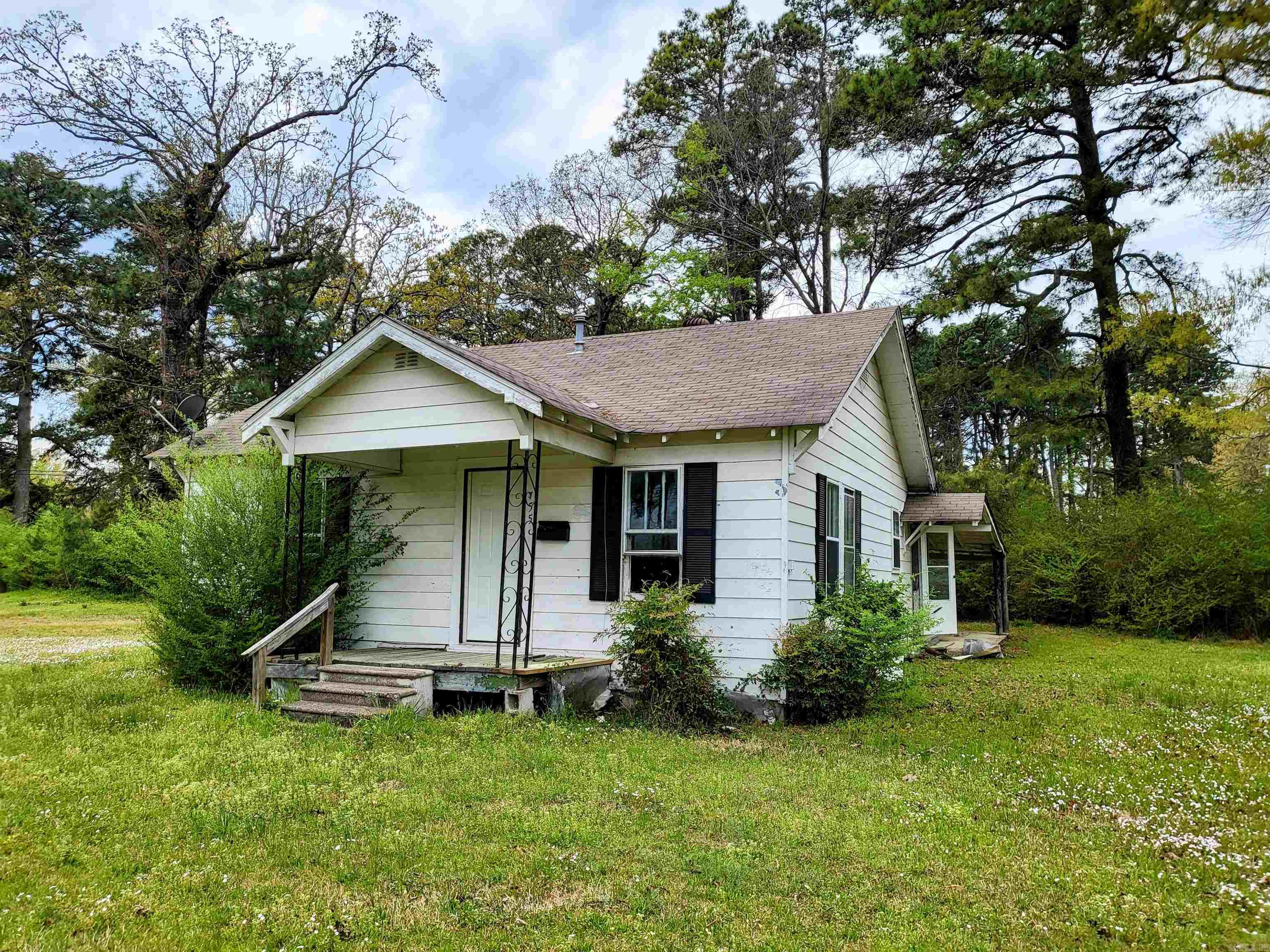 Charming 2-Bedroom Home on a Spacious Corner Lot! Welcome to this adorable 2-bedroom, 1-bath home, perfectly situated on almost a half-acre corner lot just a few blocks from Prescott schools. Built in 1952, this cutie boasts much of its original charm including hardwood floors flowing through the living room and bedrooms, complemented by charming wood plank ceilings. The Jack and Jill hallway offers seamless access to the bathroom between bedrooms, while a bonus room off of the 2nd bedroom provides the opportunity to create a third bedroom, nursery, home office, or hobby space. The kitchen is spacious and features an alcove for a dining table and a dedicated laundry room, offering extra convenience. Outside, the spacious lot provides endless potential for gardening, entertaining, or storage for your boat when you're done fishing. Nestled in a recreational haven, this home is close to fantastic fishing spots and outdoor adventures—perfect for nature lovers! With just a little love, this beauty will truly shine. Schedule a private showing with an agent today. Agents see comments. Home is being sold as-is where-is.