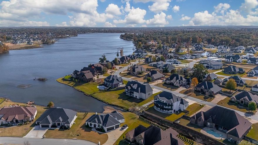 Welcome to your dream estate in the prestigious Hurricane Lake Estates! This immaculate 5 bedroom, 6 bath home offers an expansive 6,000 square feet of luxurious living space, all situated on a stunning 0.51-acre lot with breathtaking lake views. Step inside to discover a beautifully designed chef's kitchen, complete with hidden butler's pantry, high-end appliances, exquisite cabinetry, and luxury fixtures. Each of the 5 spacious bedrooms is accompanied by its own full bathroom, ensuring privacy and comfort for family and guests alike. For movie enthusiasts, the private theater room offers the perfect escape to unwind. Enjoy the outdoors from one of the 3 expansive wrap-around balconies, where you can take in panoramic views of the serene lake. The fully finished walk-out basement provides additional living space, ideal for recreation or relaxation. This home is equipped with a whole-house generator, storm shelter room, laundry shute & lawn sprinkler system. The oversized three-car garage offers ample storage. This luxury property truly offers everything you could desire in a home and more—perfect for those seeking elegance, comfort, and a touch of sophistication.