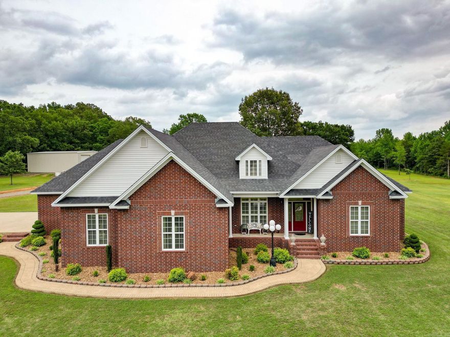 Custom built beautiful home sitting pretty on 20+ acres of manicured lawn!  This 3 bdrm 2 bth home is IMMACULATE when I say you will have to do nothing that is exactly what I mean!  Beautiful hard surface flooring Gourmet kitchen with an island, pull outs in every cabinet, built in pantry, deep drawers for those crock pots, Undermount counter light, breakfast bar seating, granite countertops, breakfast dining area along with formal dining.  Large columns that separate the dining room and living area, split floor plan, master is large with his and hers walk in closets. Extra wide interior doorways.  Master has walk in shower with lots of storage.  Beautiful fireplace entices you with those gas logs to turn the fire on even in the summer!   House is all electric HVAC replaced 2017 with heat pump new roof 2017 water heater 5 yrs old 6in wall construction, double trey ceiling in living area, trey ceiling in master bedroom, neutral wall colors throughout, plantation blinds and this is just the house!  40X48 red iron shop insulated, this shop is as clean as the house! Storm shelter just outside the shop.  Approx. 15 acres behind the house with a pond and woods. Quality is here!