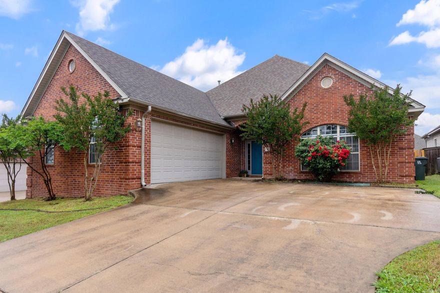 This attractive one-level brick home offers a well-designed floor plan that offers both comfort and easy flow. It boasts two spacious living areas, each with its own fireplace, as well as a separate formal dining room. The expansive family room features a gas-log fireplace, custom built-in bookcases and cabinetry, and opens into the kitchen. The bright white kitchen includes a generous cook/work island, a breakfast bar, and a pantry for ample storage. The large primary suite includes a walk-in closet, sep custom shower & bath tub. The two additional bedrooms also offer ample closet space. A dedicated laundry area adds convenience. Outdoors, enjoy a welcoming covered patio along with an extended deck featuring built-in bench seating, all overlooking a fenced backyard.