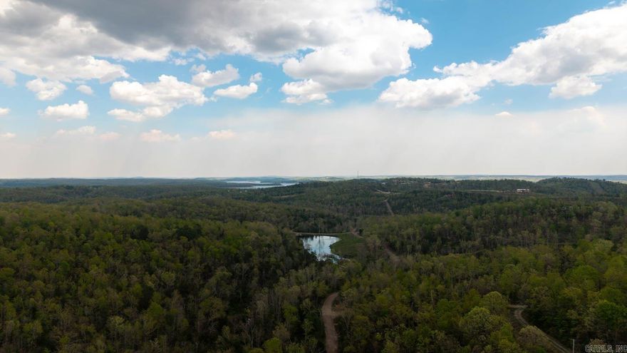 Acreage Near Norfork Lake & White River  This 3.31± acre property near Mountain Home offers a great opportunity to build in a prime Ozarks location. Rural water and electric are available at the county road, and the property has already passed a perc test, making it ready for future development. A year-round spring runs through the land, adding natural beauty and a unique feature to the setting. Located just minutes from Norfork Lake and the White River, you will have easy access to clear water, boating, and world-class trout fishing, along with canoeing and kayaking. Whether you are planning to build your forever home or invest in land, this property offers both convenience and outdoor lifestyle appeal.